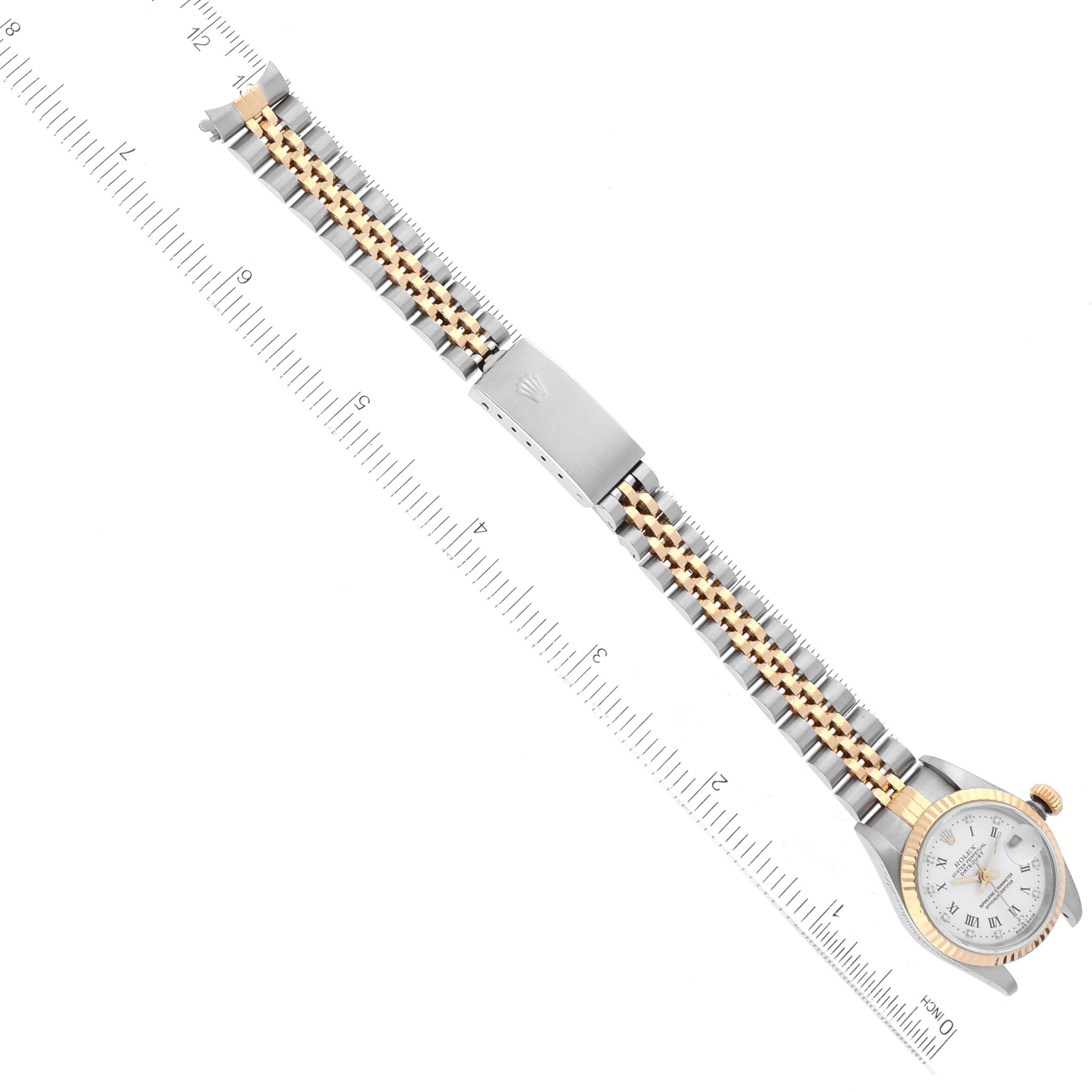 The image shows a top-down view of a Rolex Datejust 79173 Women's Steel and Gold (two tone) White Dial 79173 Women's Steel and Gold (two tone) White Dial watch, highlighting the watch face, two-tone bracelet, and clasp.