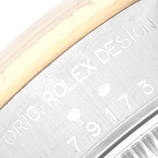 The image shows a close-up of the serial number and "ORIG. ROLEX DESIGN" engraving on the side of a Rolex Datejust 79173 Women's Steel and Gold (two tone) White Dial 79173 Women's Steel and Gold (two tone) White Dial watch case.