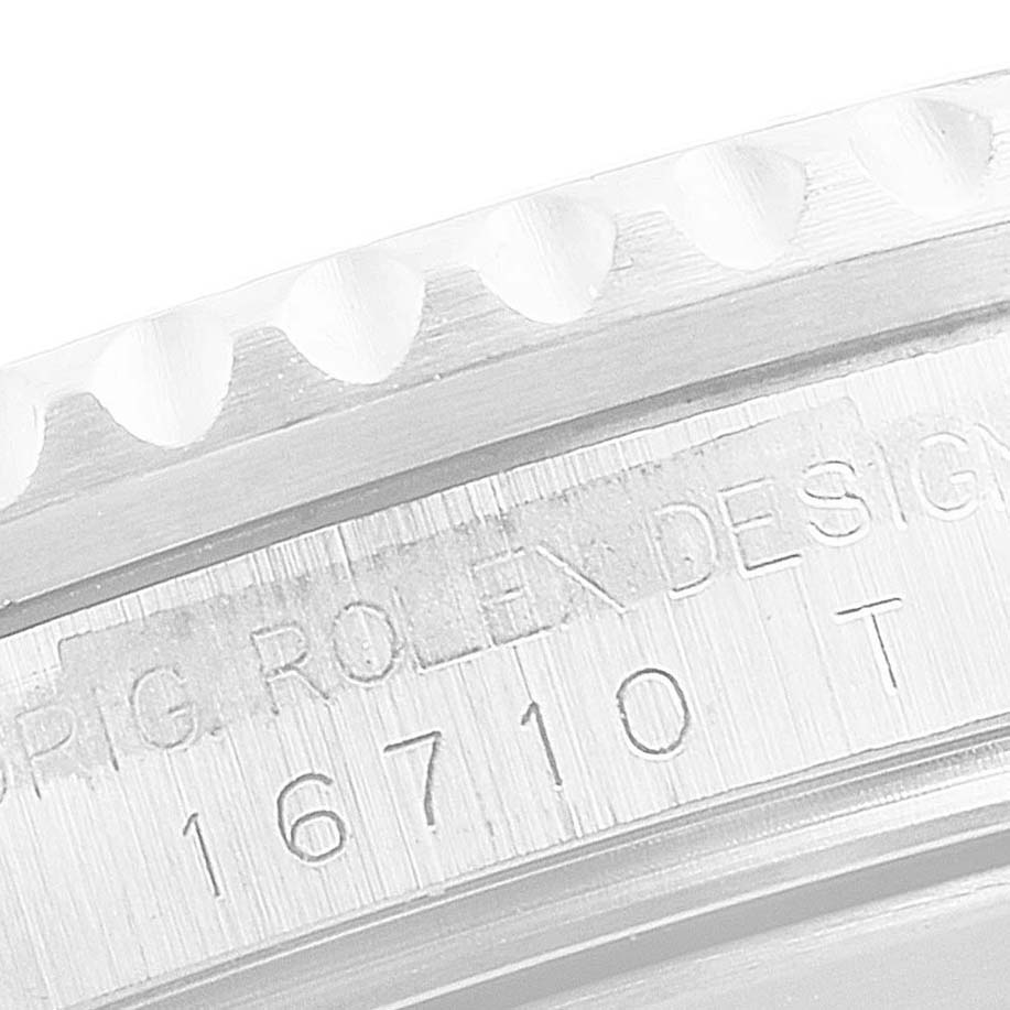 The image shows a close-up view of the engraved bezel and model number "16710" of a Rolex GMT-Master 16710 Men
s Stainless Steel Black Dial 16710 Men
s Stainless Steel Black Dial watch.