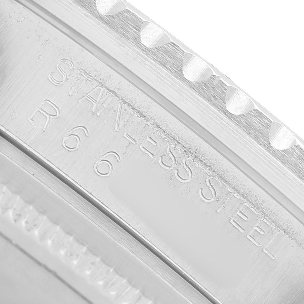 The image shows a close-up of the engraved stainless steel bezel's edge of a Rolex GMT-Master 16750 Men's Stainless Steel Black Dial watch.