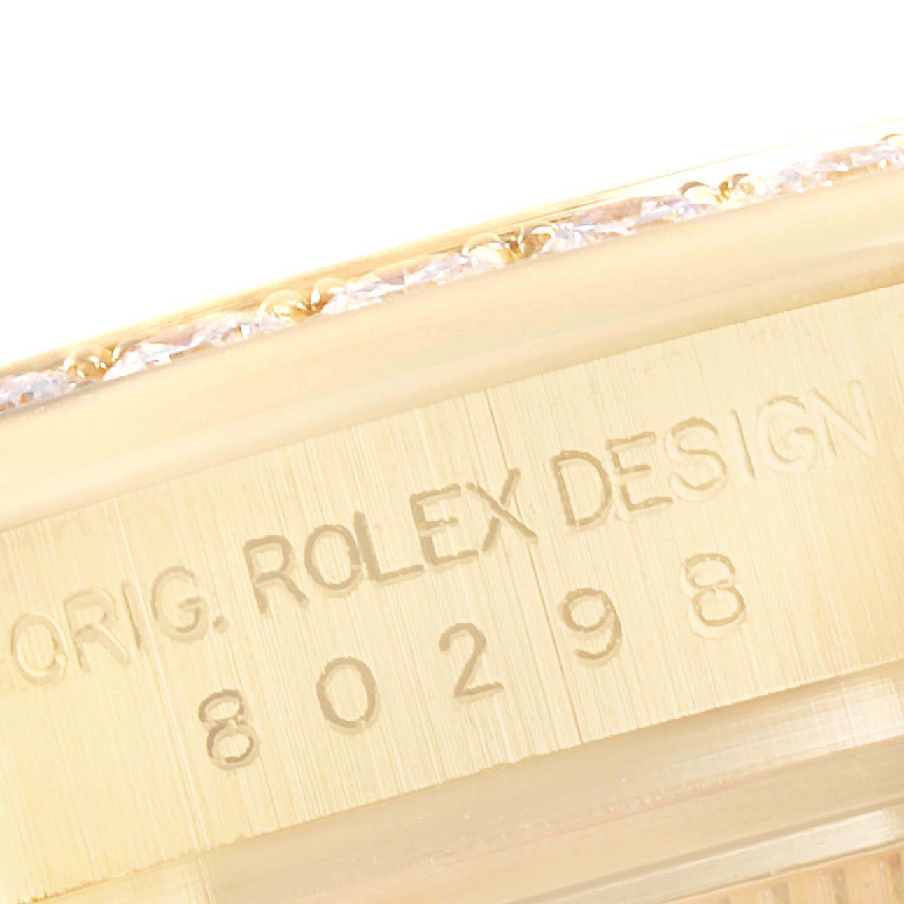 The image shows a close-up of the Rolex Pearlmaster 80298 Women's Yellow Gold Mother of Pearl Dial 80298 Women's Yellow Gold Mother of Pearl Dial model's bezel and case side, displaying the engraving.