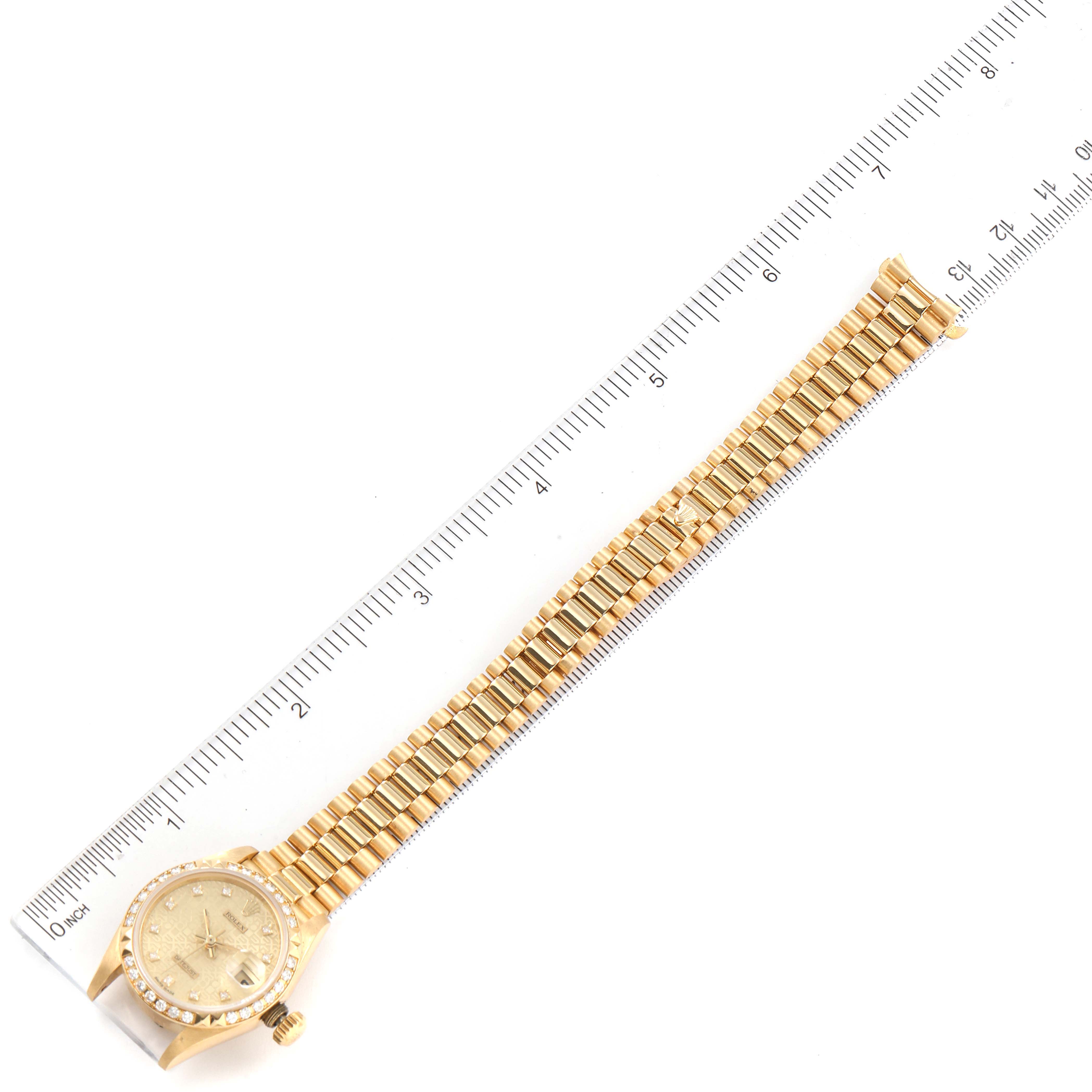The image shows a Rolex President 69268 Women
s Yellow Gold Champagne Dial 69268 Women
s Yellow Gold Champagne Dial model watch laid flat with a ruler beside it, displaying the full bracelet and watch face.