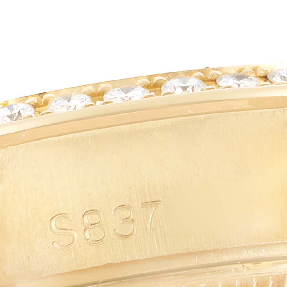 This is a close-up of the Rolex President 69268 Women
s Yellow Gold Champagne Dial 69268 Women
s Yellow Gold Champagne Dial model, showing a portion of its gold band with a serial number "S837" and diamond accents.