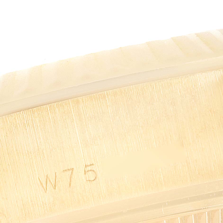 This image shows a close-up angle of the engraved bezel or case side of a Rolex President 69178 Women
s Yellow Gold Beige Dial 69178 Women
s Yellow Gold Beige Dial model watch.