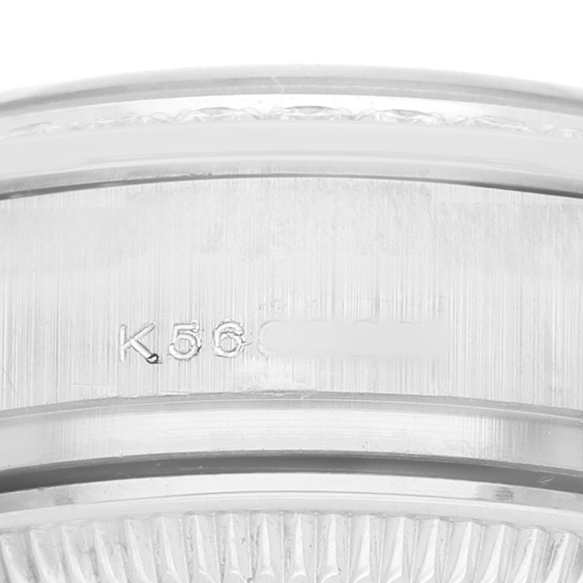 The image shows a close-up of the Rolex President 179136 Women's Platinum Blue Dial model's watch bezel and part of the engraved serial number.