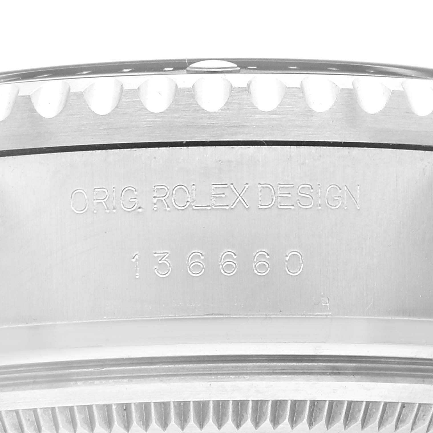 The image shows a close-up of the side of the bezel and case back of a Rolex Sea-Dweller 136660 Men's Stainless Steel Blue Dial 136660 Men's Stainless Steel Blue Dial, revealing its engraved serial number.