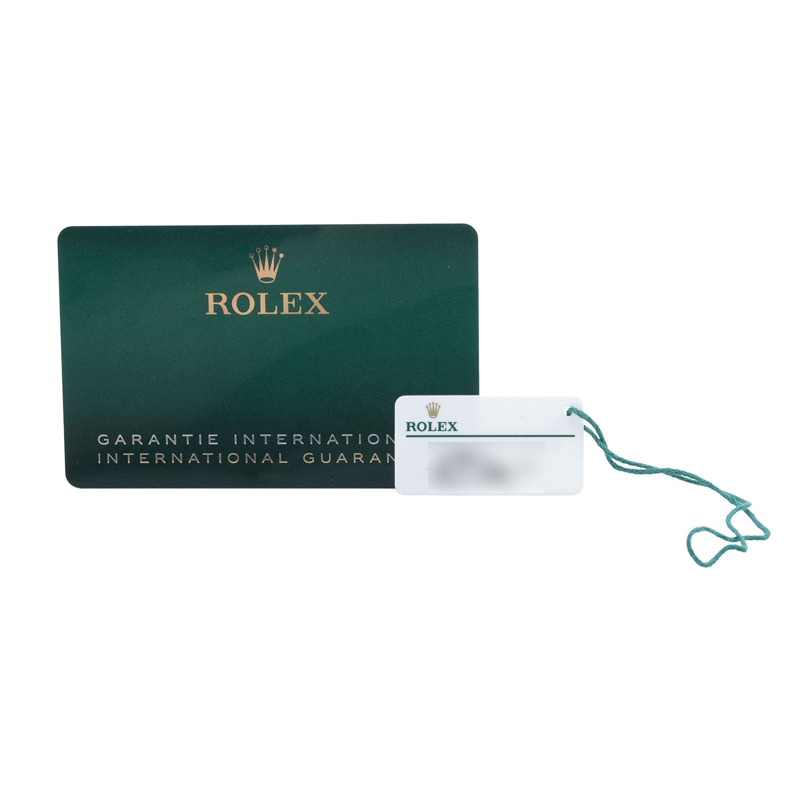 The image shows a Rolex Submariner 124060 Men's Stainless Steel Black Dial warranty card and a white tag with a green string.