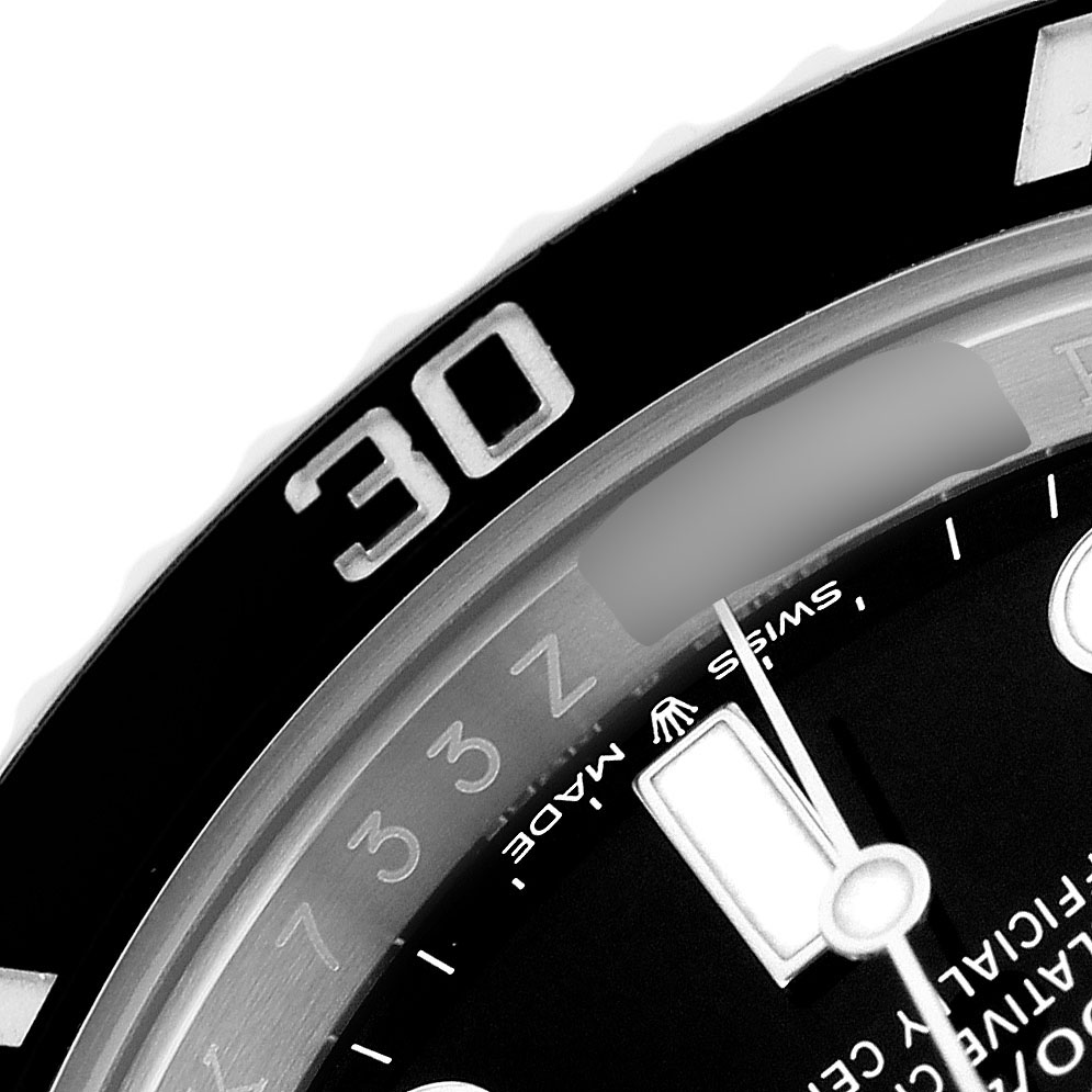 The image shows a close-up of the Rolex Submariner 124060 Men's Stainless Steel Black Dial's bezel, dial, and part of the minute hand.
