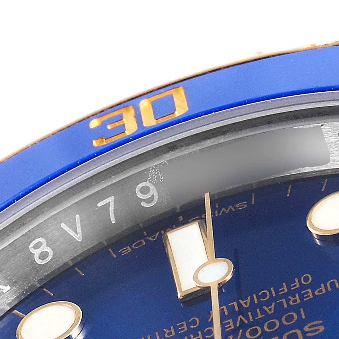 This close-up image of a Rolex Submariner 116613 Men's Steel and Gold (two tone) Blue Dial 116613 Men's Steel and Gold (two tone) Blue Dial showcases the blue bezel, part of the dial, and the minute hand.