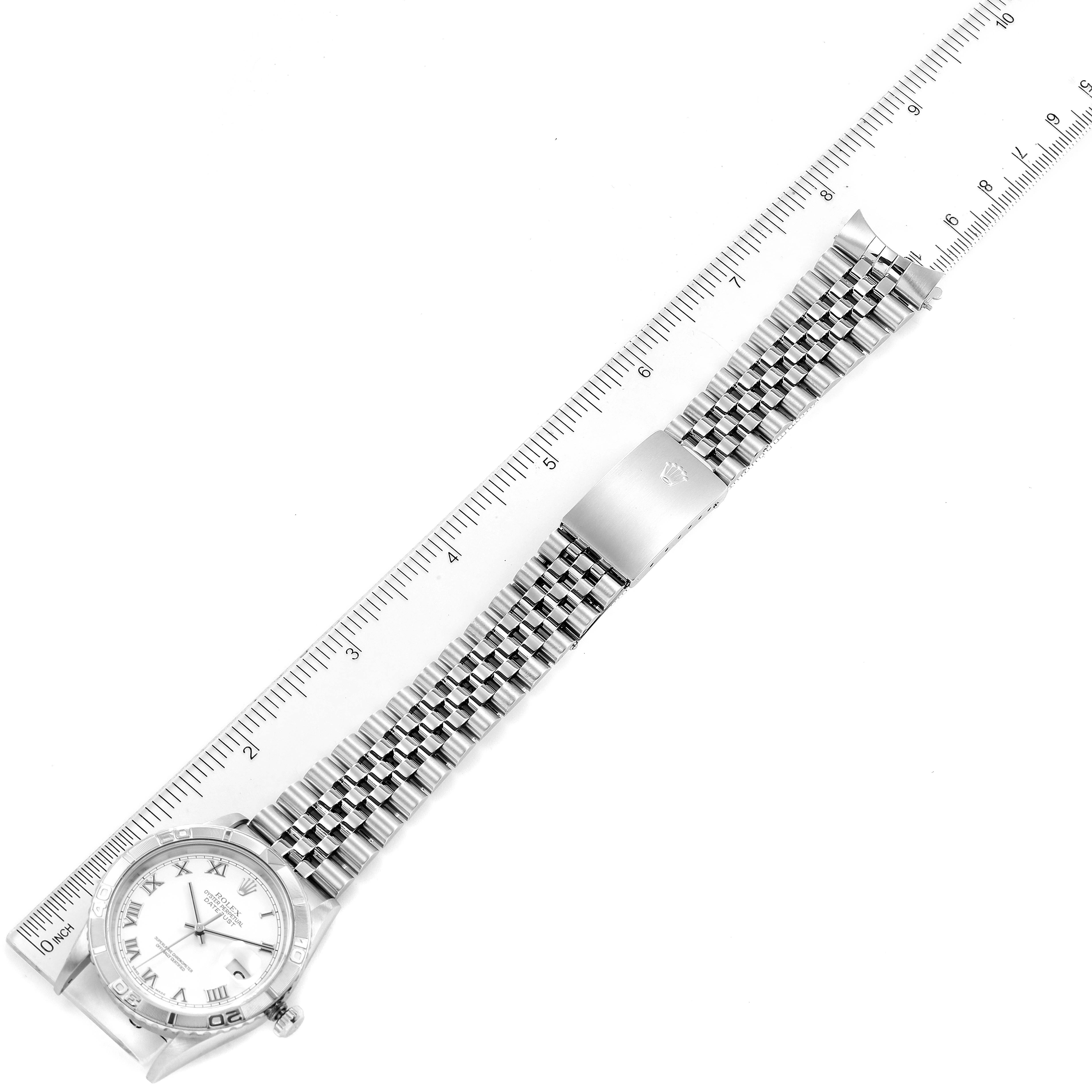 This image shows a top-down view of a Rolex Turn-o-Graph 16264 Men's Stainless Steel White Dial 16264 Men's Stainless Steel White Dial watch, highlighting the dial, bracelet, and clasp alongside a ruler for scale.