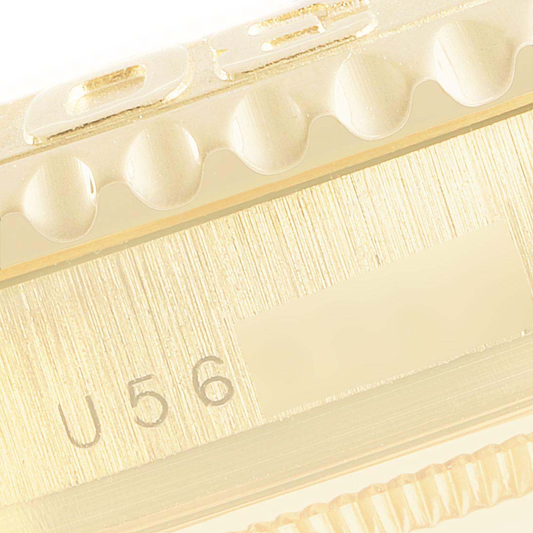 This image shows a close-up of the bezel and case serial number of a Rolex Yacht-Master 16628B Men's Yellow Gold White Dial 16628B Men's Yellow Gold White Dial watch.