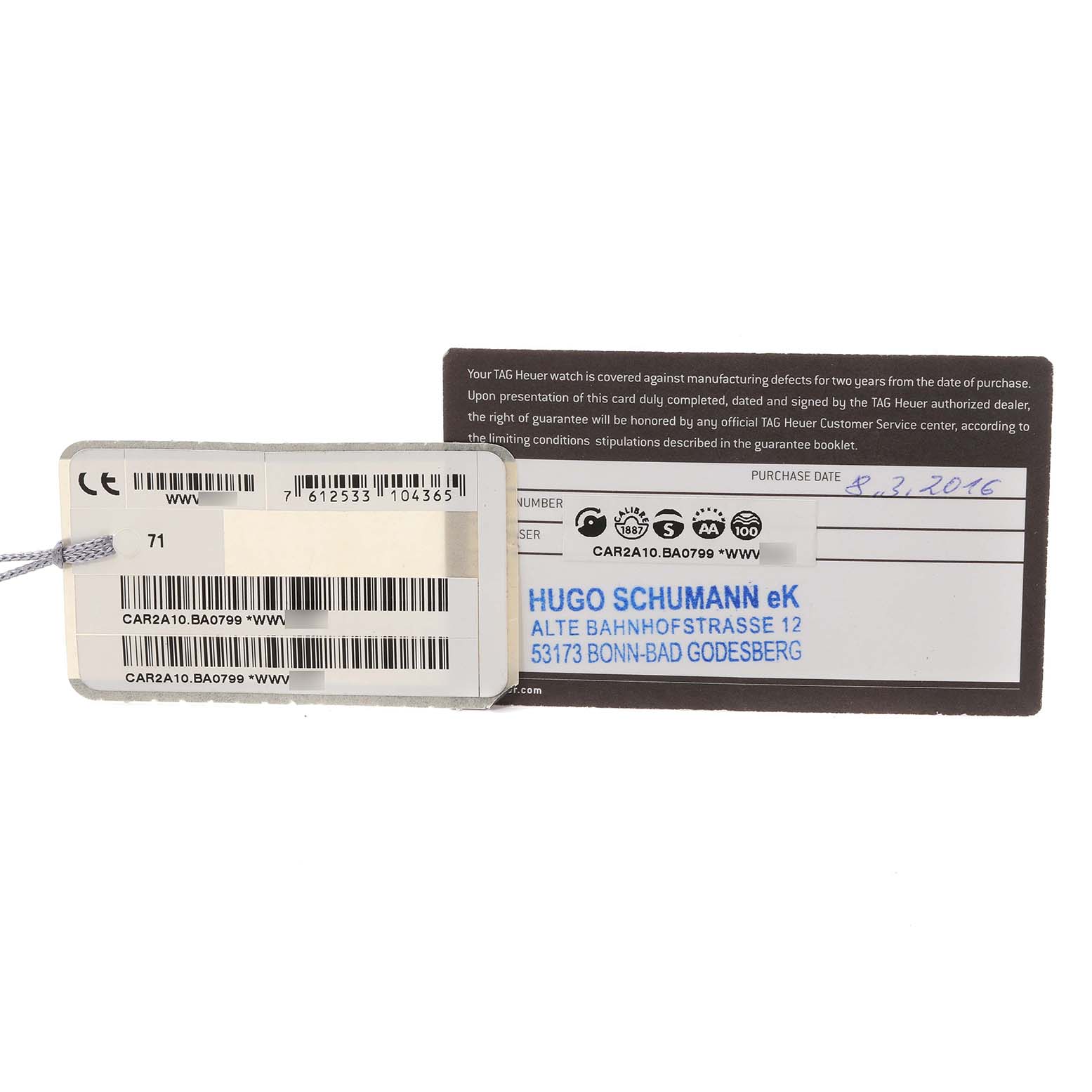 The image shows warranty and identification tags for a Tag Heuer Carrera CAR2A10 Men's Stainless Steel Black Dial CAR2A10 Men's Stainless Steel Black Dial model watch.