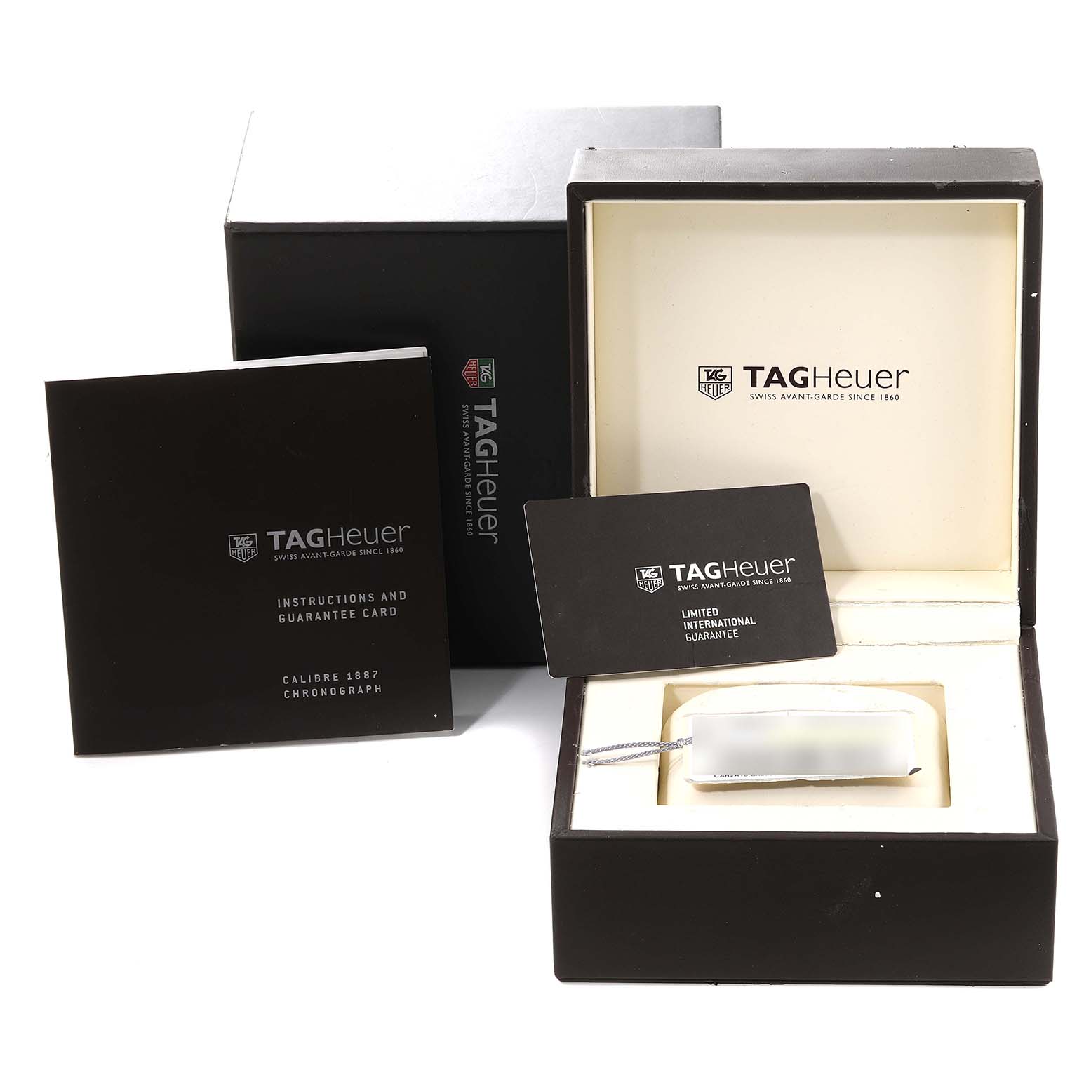 The image shows the packaging and accessories of a Tag Heuer Carrera CAR2A10 Men's Stainless Steel Black Dial CAR2A10 Men's Stainless Steel Black Dial model, including the watch box, instructions, and guarantee card.