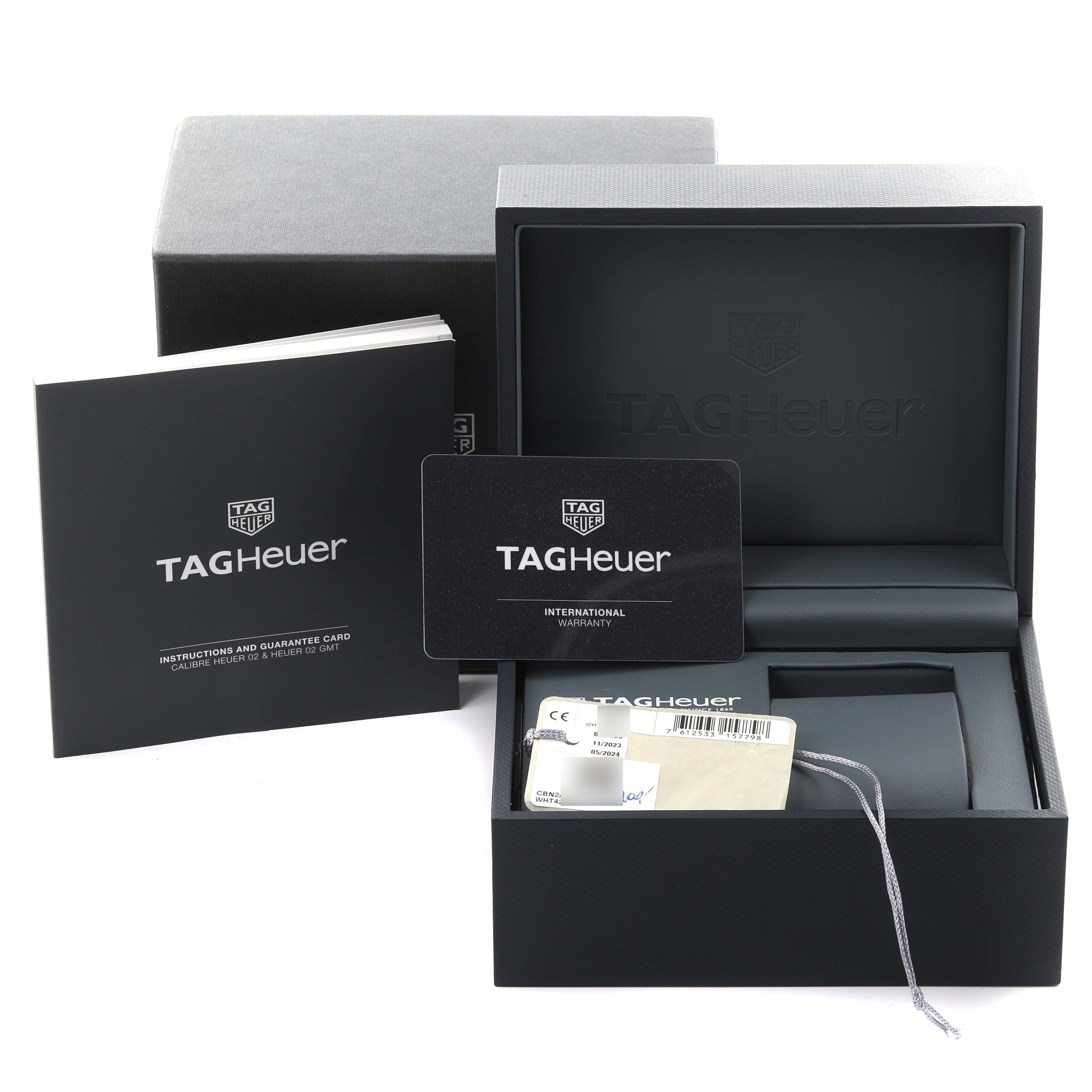 The image shows a Tag Heuer Carrera CBN2A5A.FC6481 Men's Stainless Steel Black Dial CBN2A5A.FC6481 Men's Stainless Steel Black Dial watch box, warranty card, and instruction manual from a front angle.