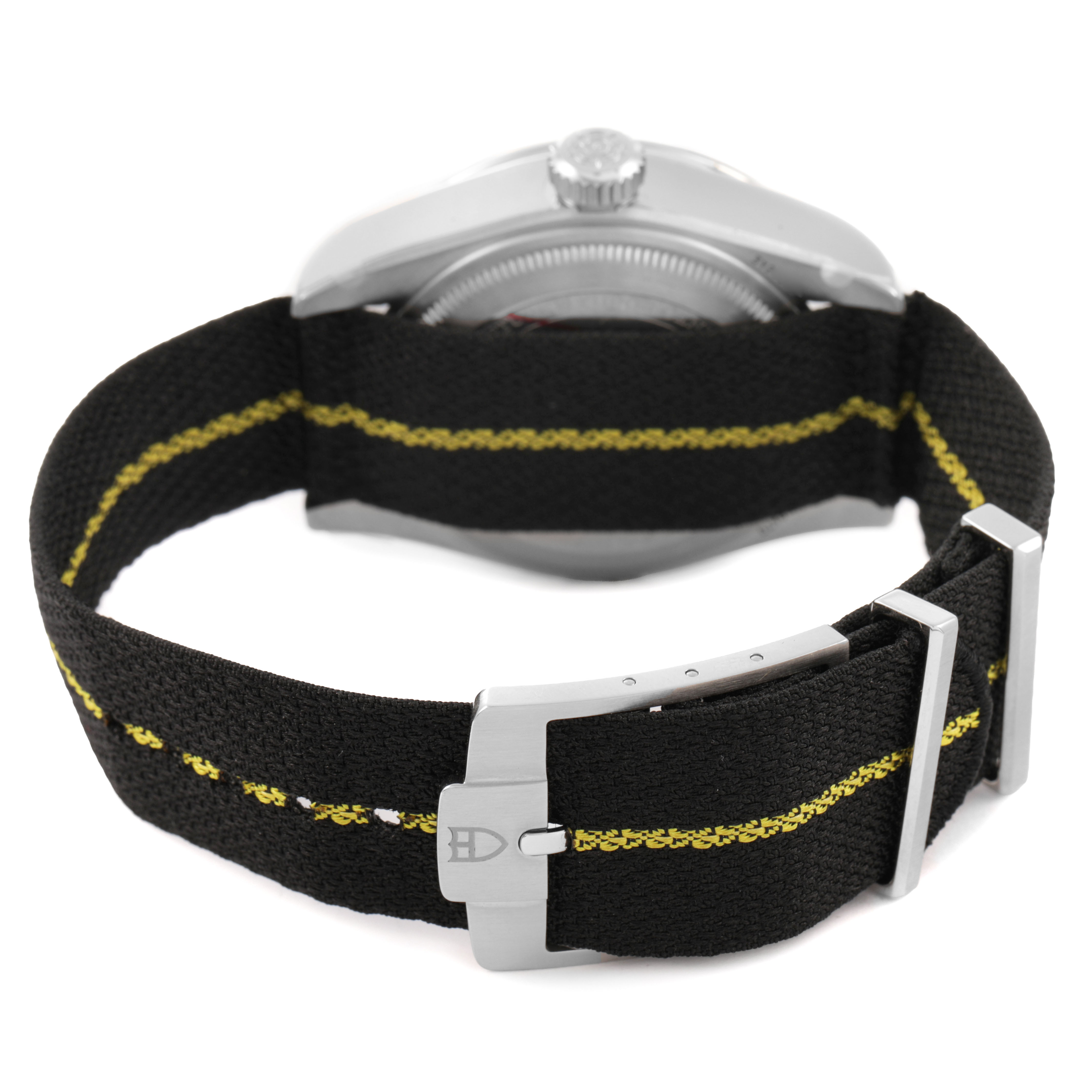 The image shows a rear angle of the Tudor Heritage Black Bay 79470 Men's Stainless Steel Black Dial, highlighting its black and yellow fabric strap and clasp.