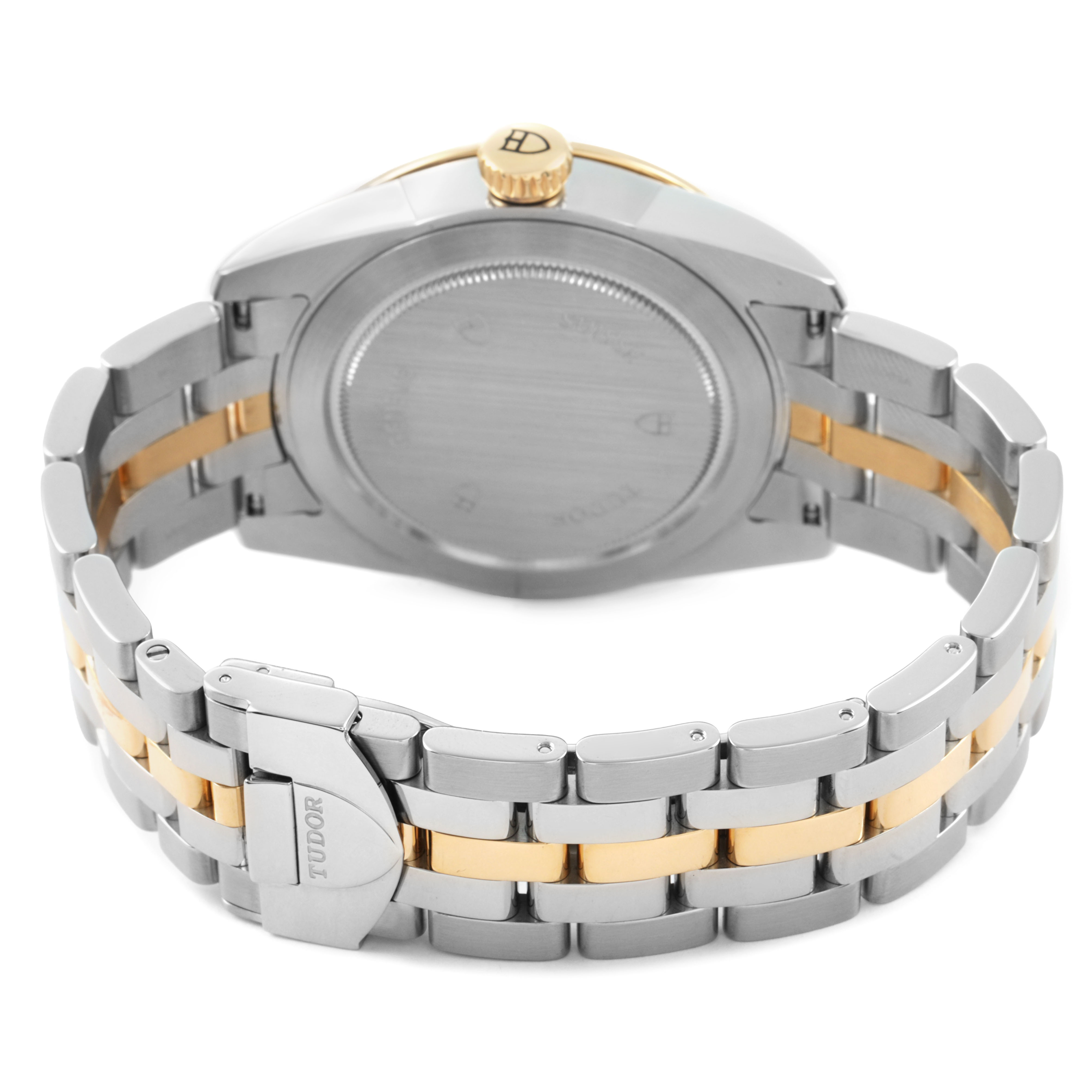 The Tudor Glamour 56003 Men's Steel and Gold (two tone) Champagne Dial model is shown from the back, highlighting the case back, crown, and two-tone bracelet.