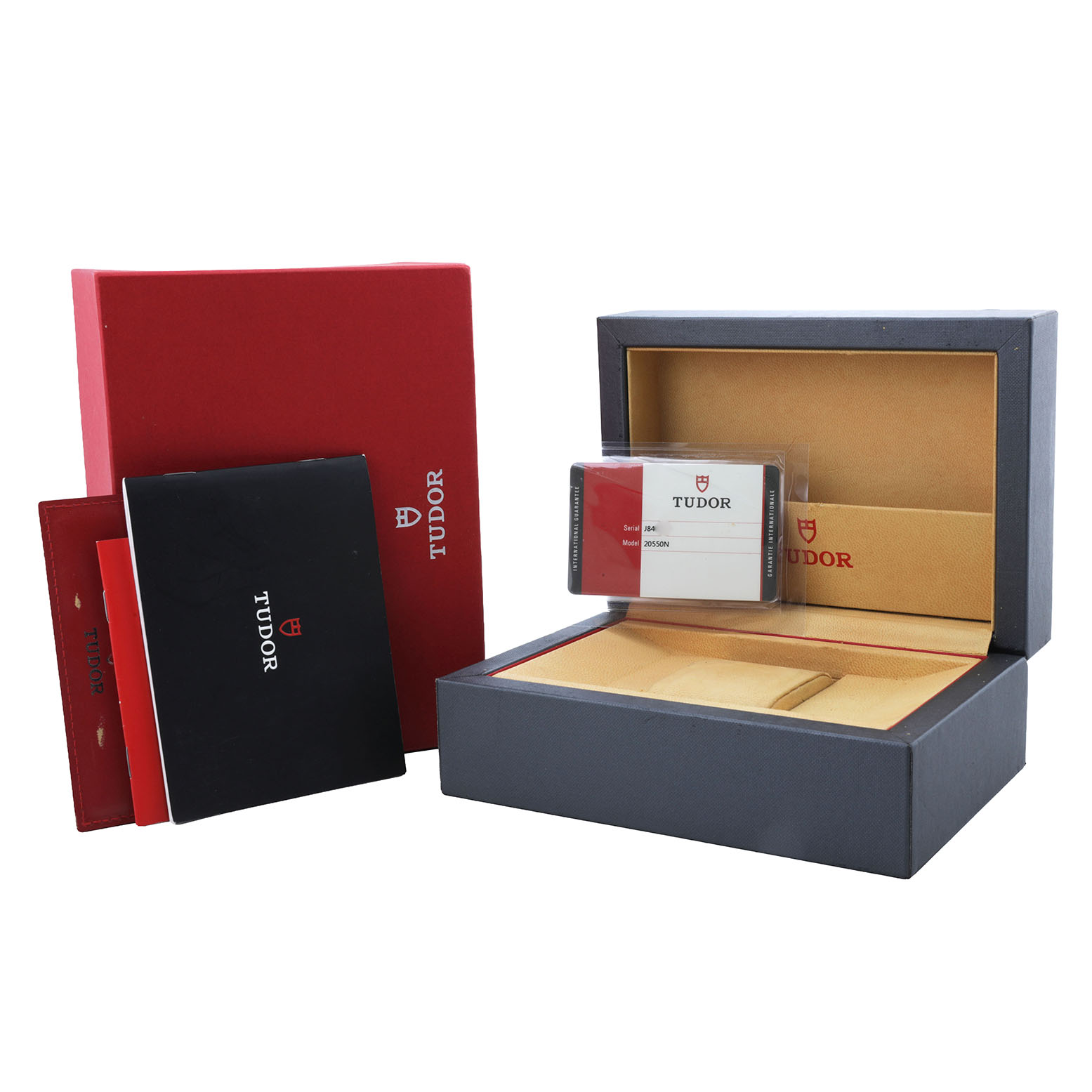The image shows the packaging and accessories for a Tudor Glamour 20550N-95730 Men's Stainless Steel White Dial model watch, including a box, card, and booklets.