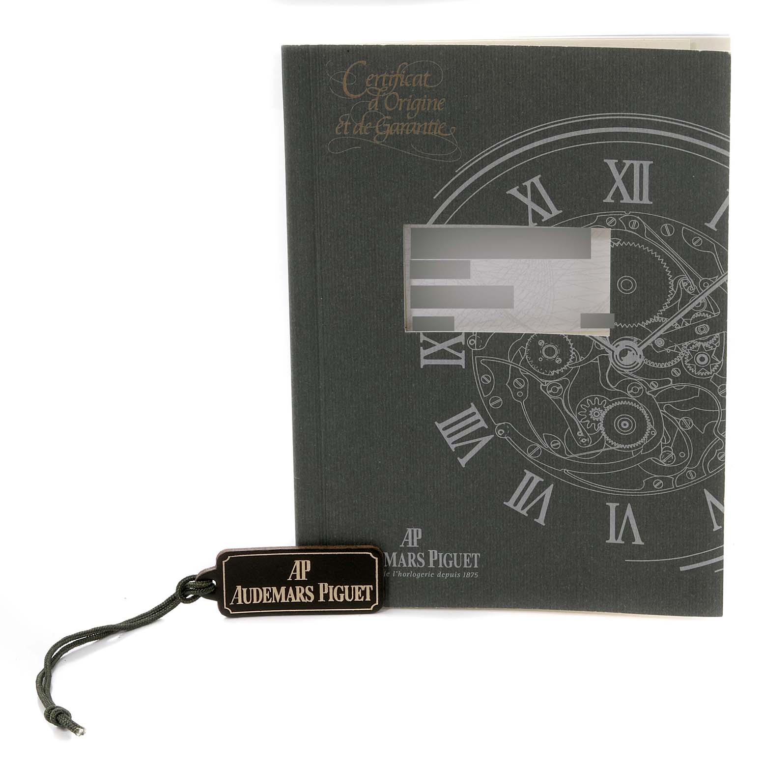 This image shows the certificate of origin and a branded tag for the Royal Oak model by Audemars Piguet.