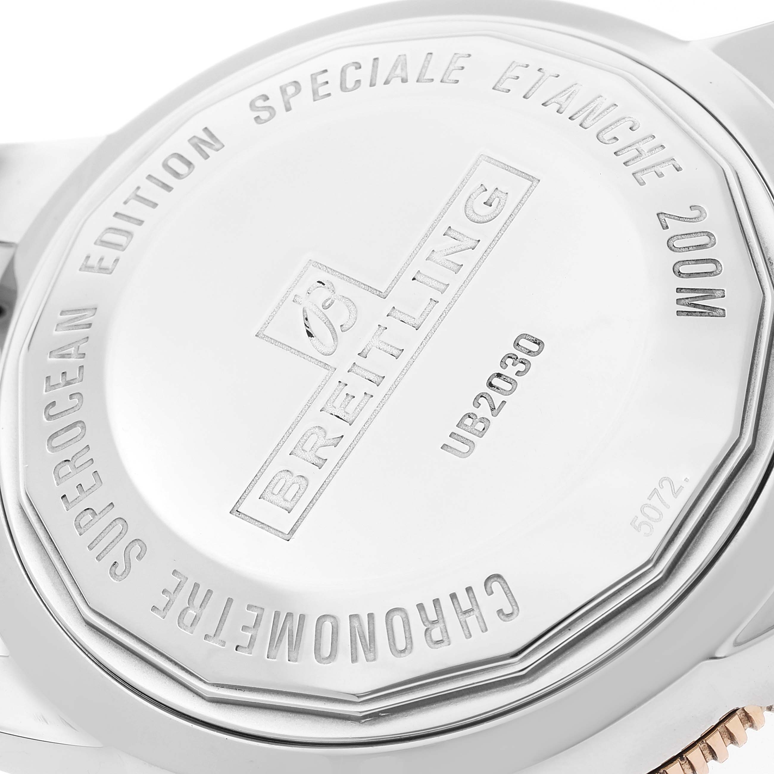 The image shows the back case of a Breitling Superocean UB2030121B1A1 Men's Steel and Gold (two tone) Black Dial UB2030121B1A1 Men's Steel and Gold (two tone) Black Dial watch with engraved details.