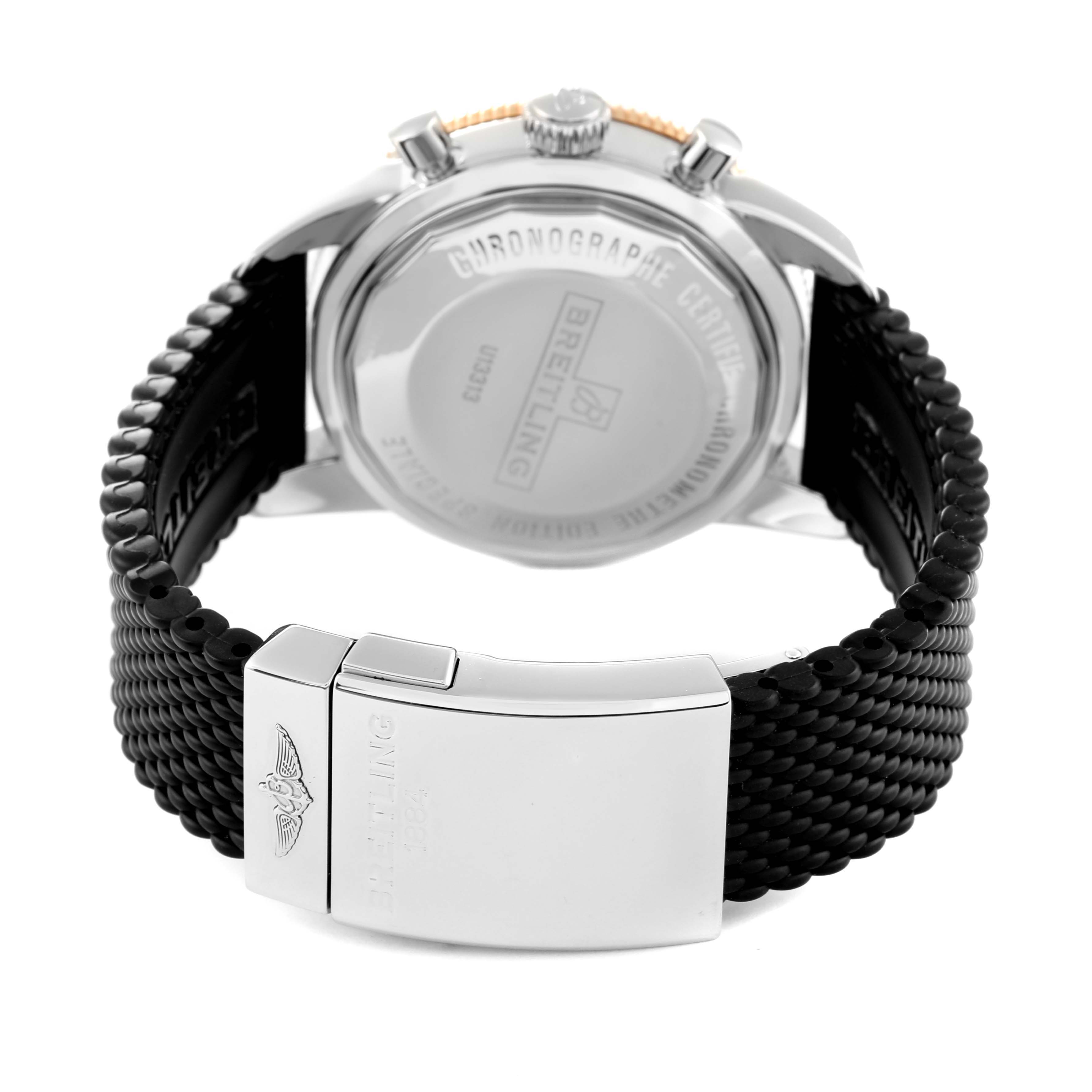 This image shows the back of a Breitling Superocean U1331312/BG50/279S/A20D.4 Men's Steel and Gold (two tone) Black Dial U1331312/BG50/279S/A20D.4 Men's Steel and Gold (two tone) Black Dial watch, featuring the case back and a black textured strap with a clasp.