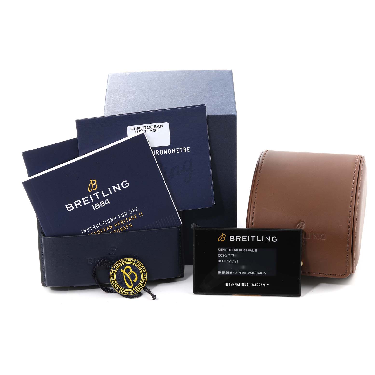 The image shows Breitling Superocean U1331312/BG50/279S/A20D.4 Men's Steel and Gold (two tone) Black Dial U1331312/BG50/279S/A20D.4 Men's Steel and Gold (two tone) Black Dial model accessories, including manuals, warranty card, a box, and a leather watch case.