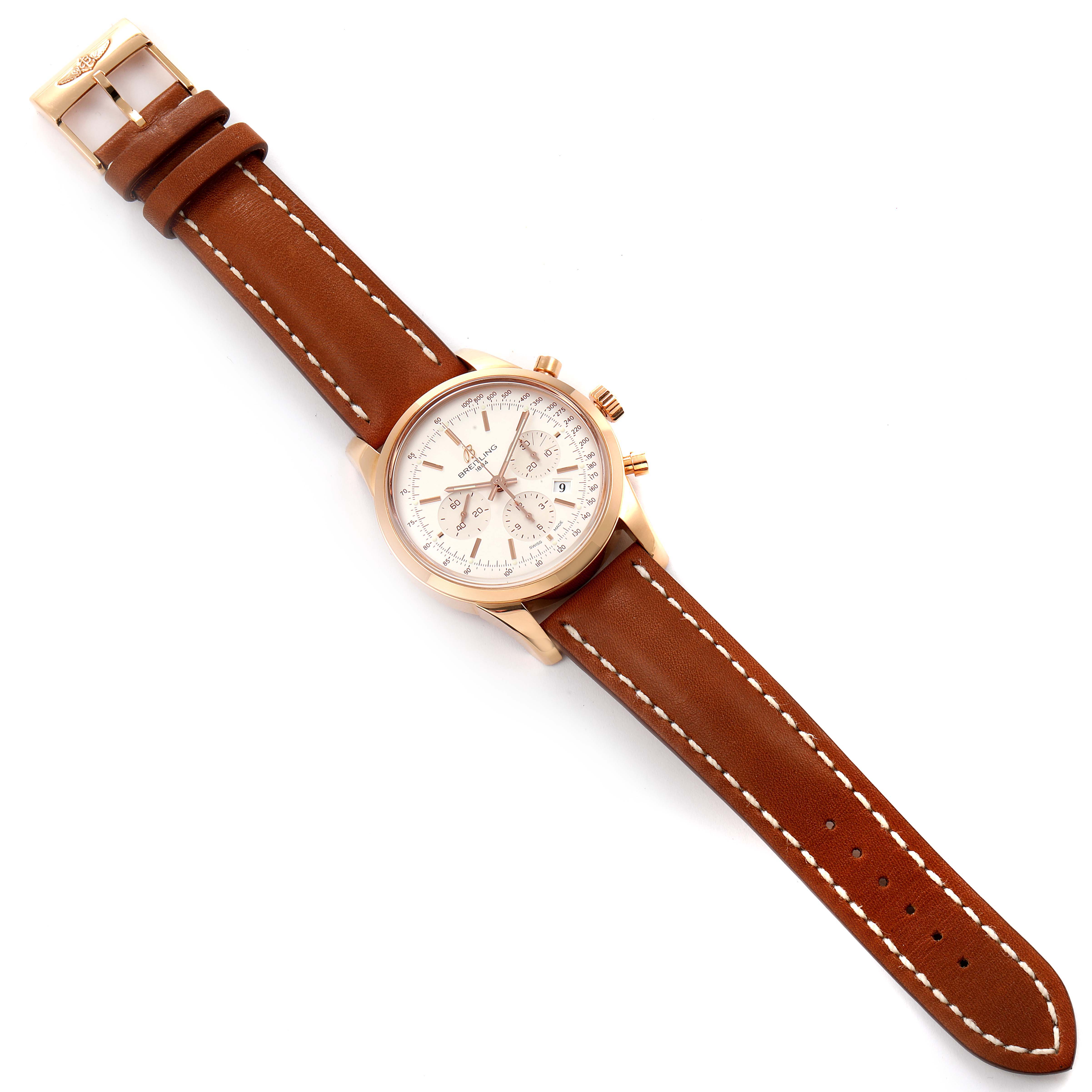 The watch, a Breitling Transocean RB0152 Men's Rose Gold Silver Dial RB0152 Men's Rose Gold Silver Dial model, is shown in a top-down angle displaying its face and brown leather strap.