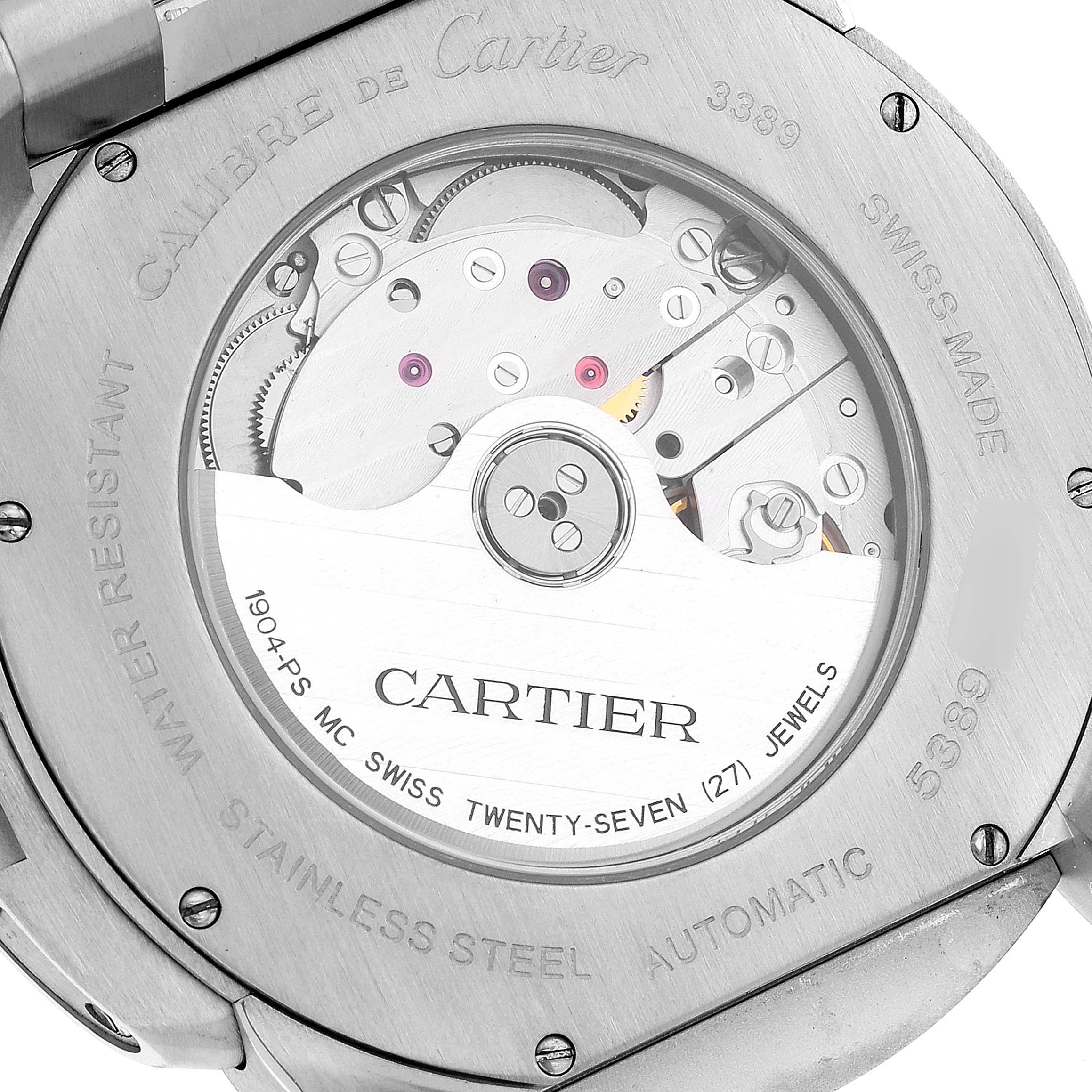The image shows the back view of the Calibre de Cartier watch by Cartier, displaying the automatic movement and inner mechanisms through the transparent case.