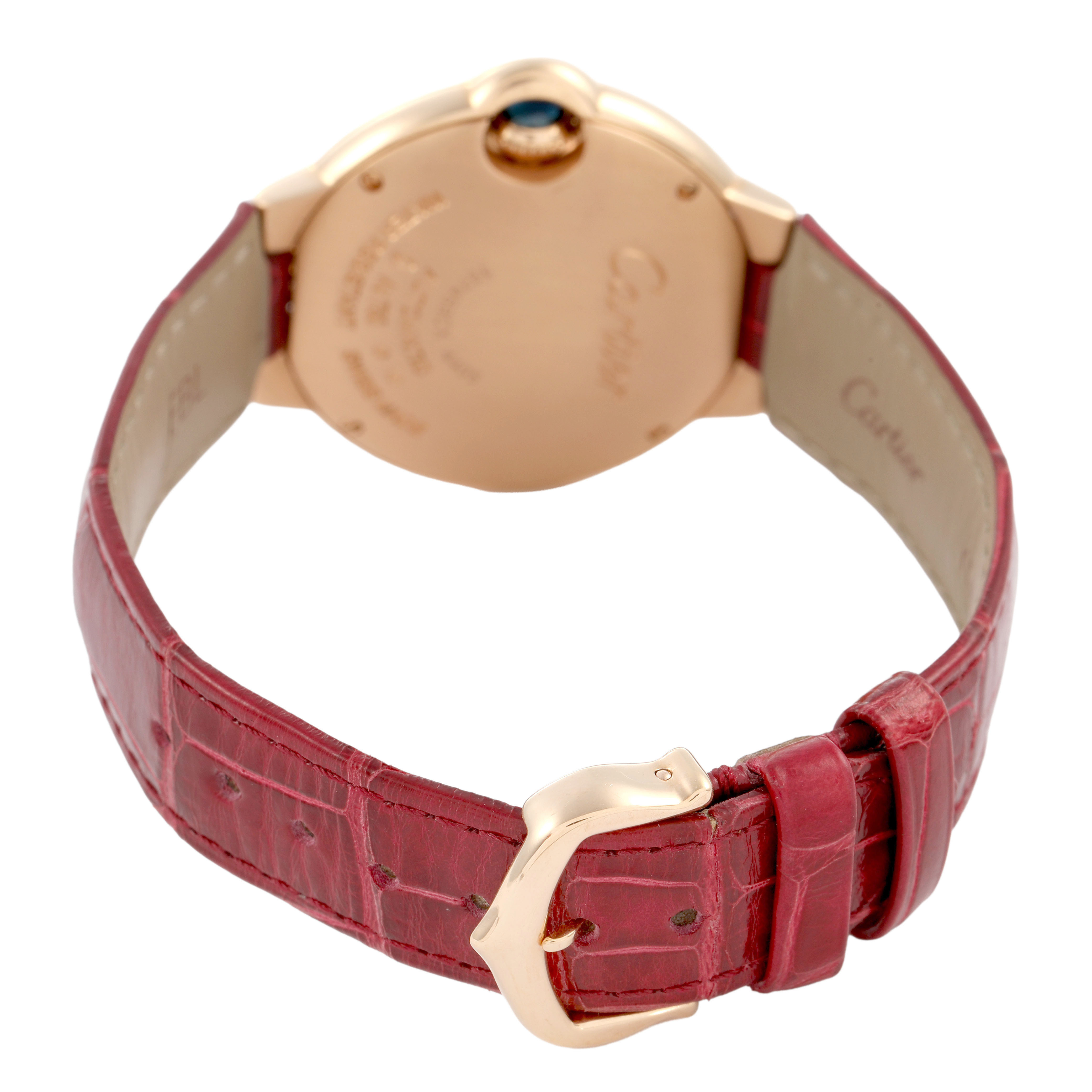 The Cartier Ballon Bleu WJBB0080 Women's Rose Gold Silver Dial watch is shown from the back, highlighting its red strap and gold buckle.