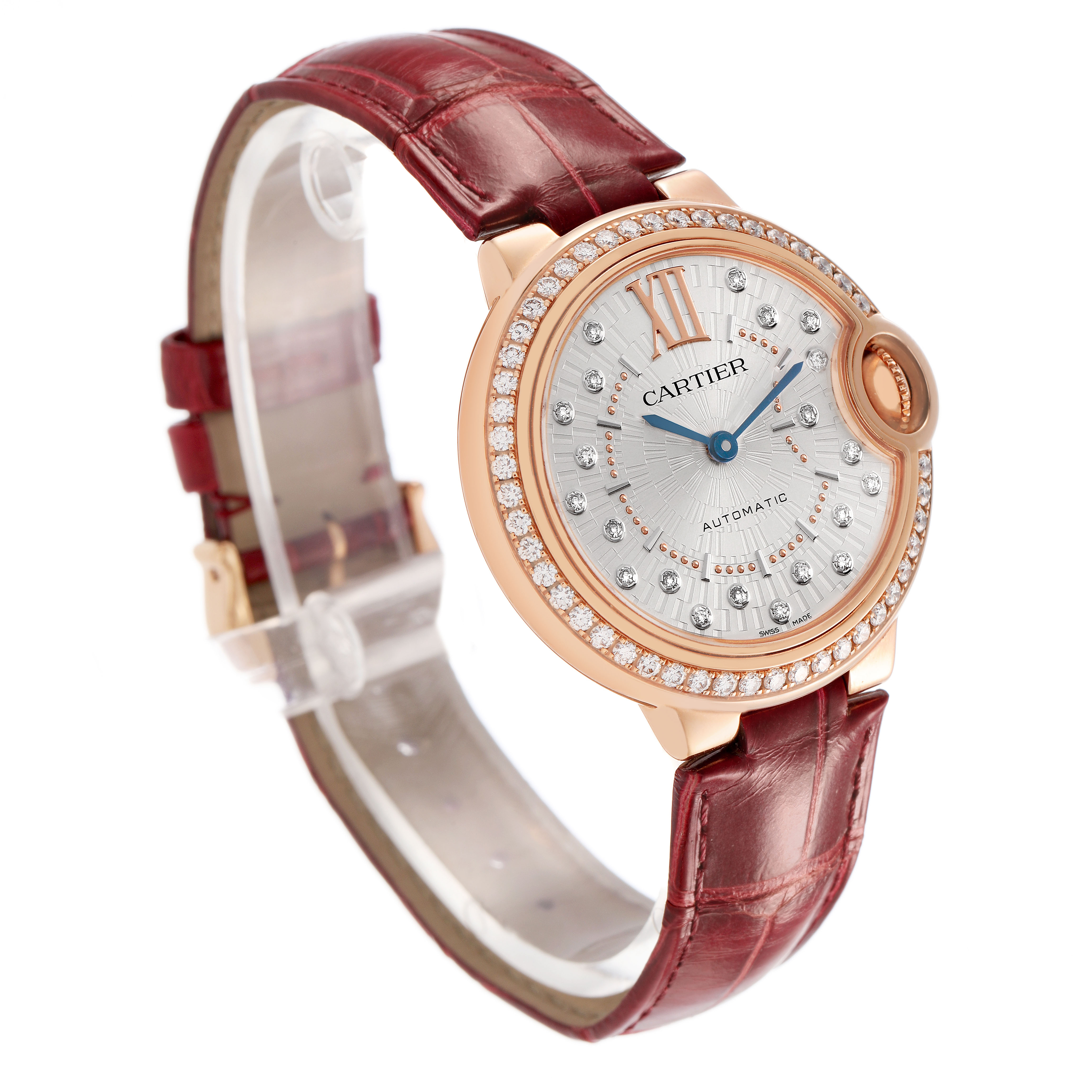 The Ballon Bleu by Cartier is shown at a three-quarter angle, highlighting the face, diamond bezel, and red leather strap.