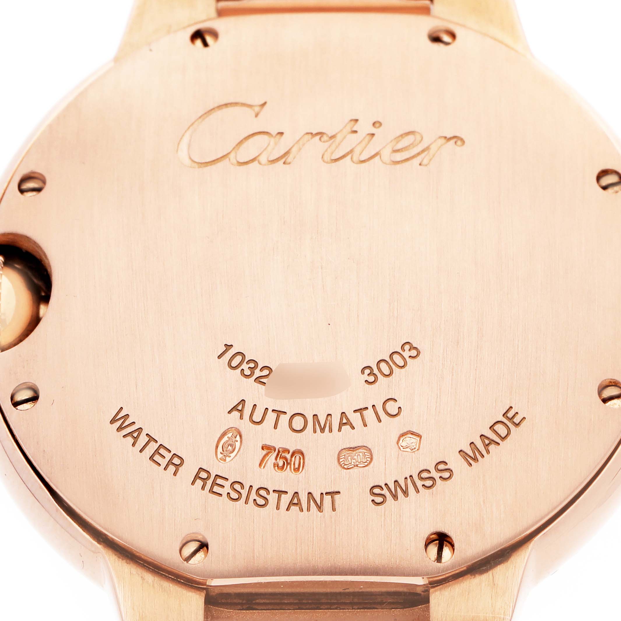 The image shows the back case of a Cartier Ballon Bleu WE9005Z3 Women's Rose Gold Silver Dial watch, highlighting engraved details and branding.