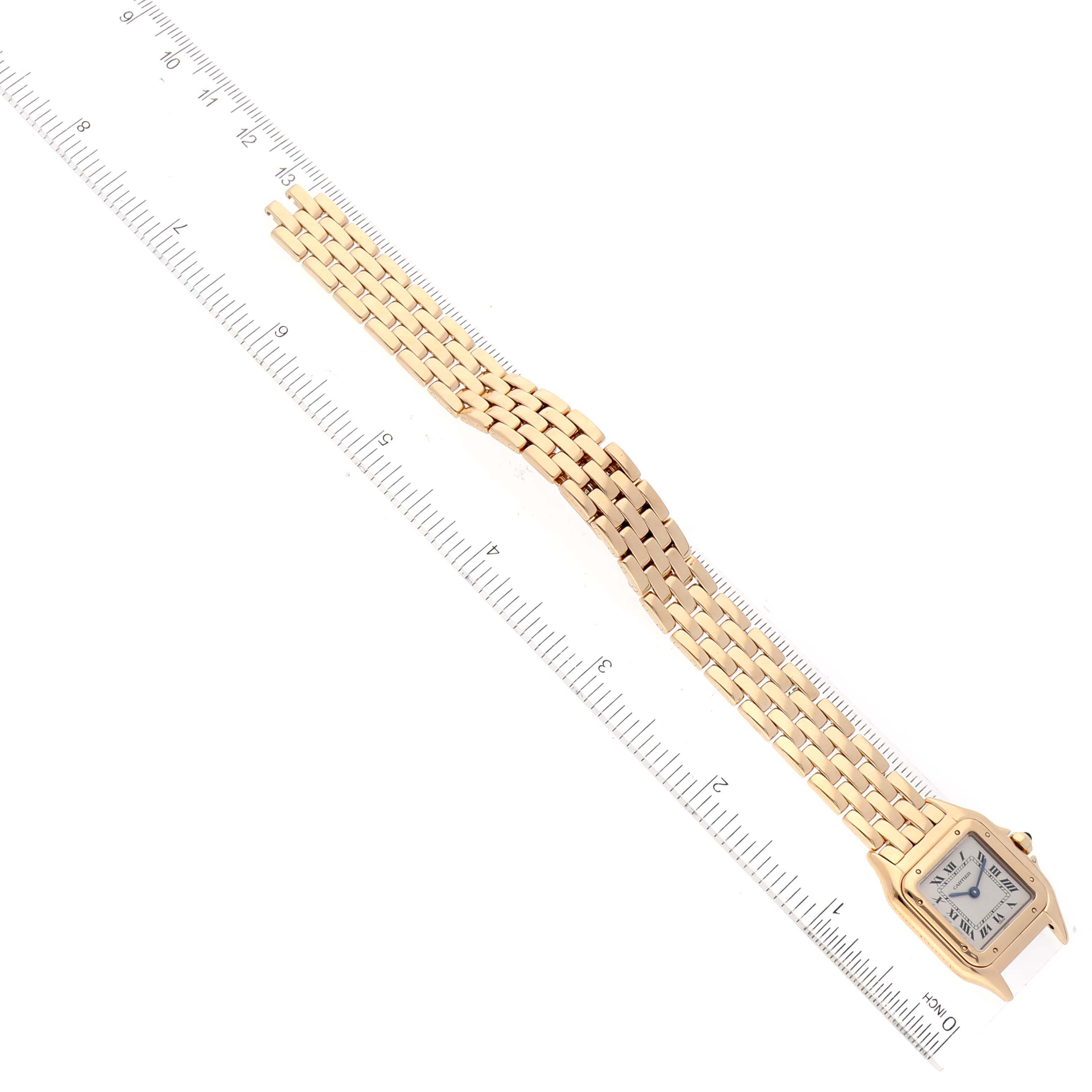 The image shows a top-down view of a Cartier Panthere W25022B9 Women's Yellow Gold Silver Dial W25022B9 Women's Yellow Gold Silver Dial watch, highlighting the rectangular face and the linked bracelet next to a ruler for measurement.