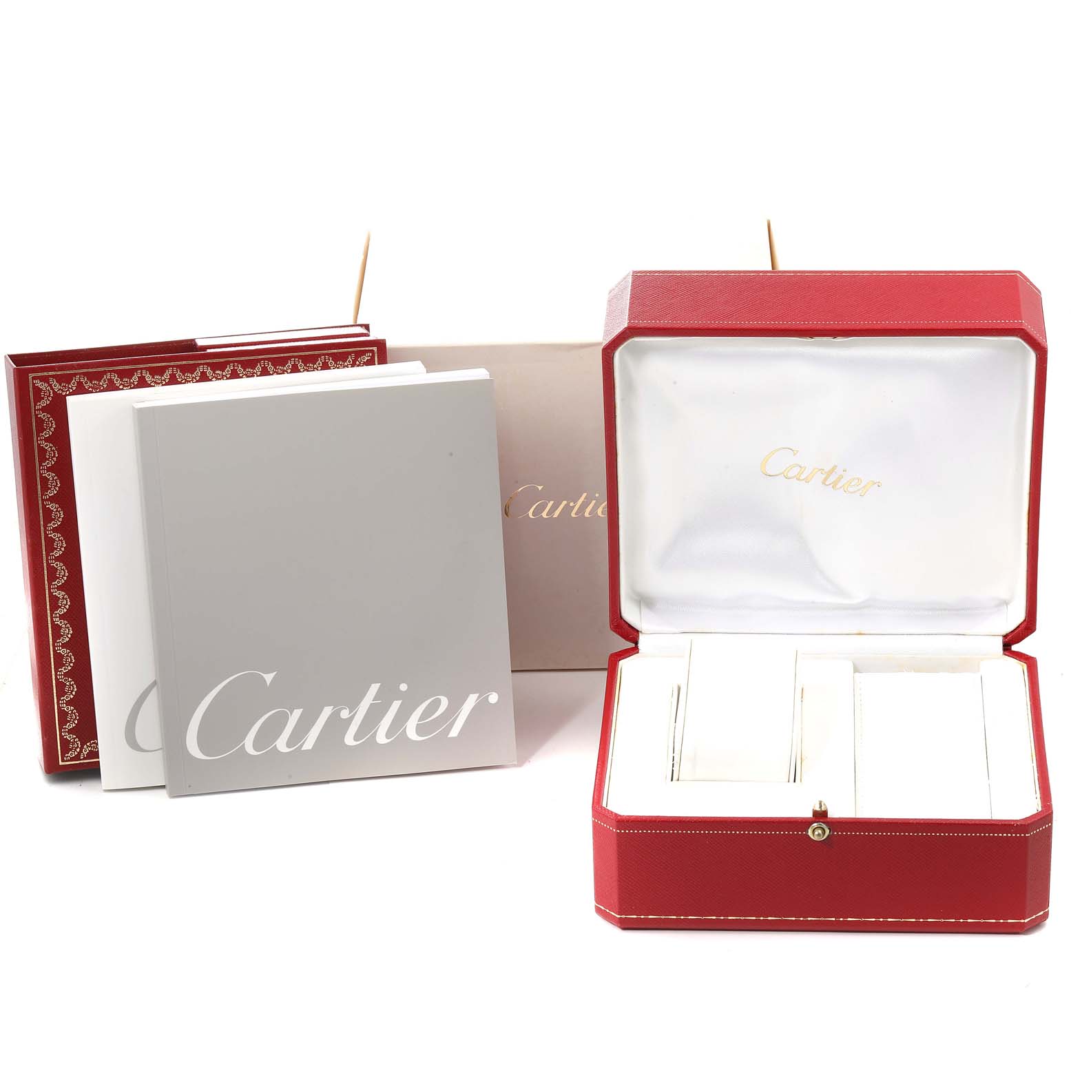 The image shows the packaging and accessories of the Cartier Roadster W62017V3 Women's Stainless Steel Pink Dial W62017V3 Women's Stainless Steel Pink Dial watch, including boxes and booklets, from a straight-on angle.