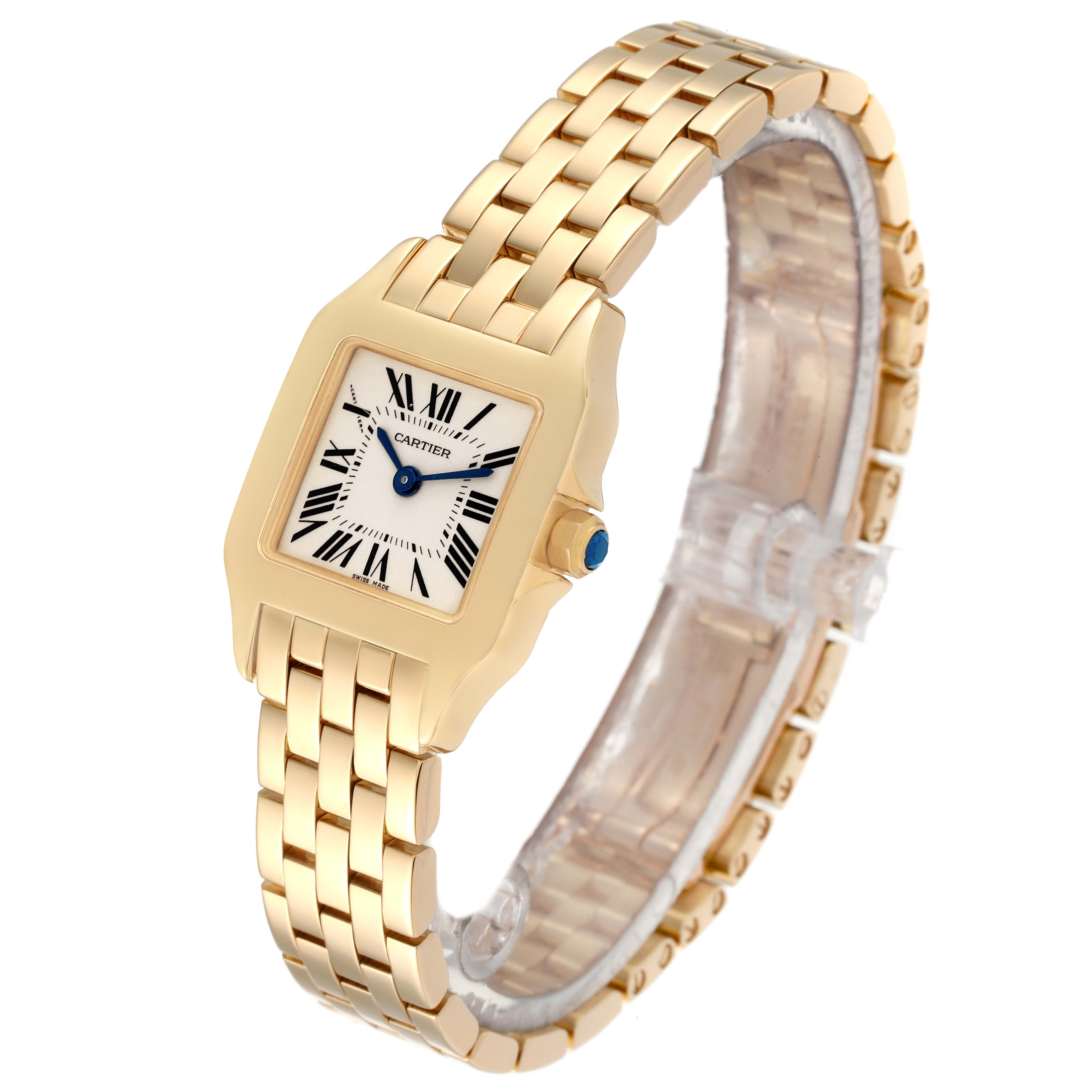 The image shows a Cartier Santos Demoiselle W25063X9 Women's Yellow Gold Silver Dial W25063X9 Women's Yellow Gold Silver Dial watch angled slightly from the front, displaying its square face, gold bracelet, and blue crown jewel.