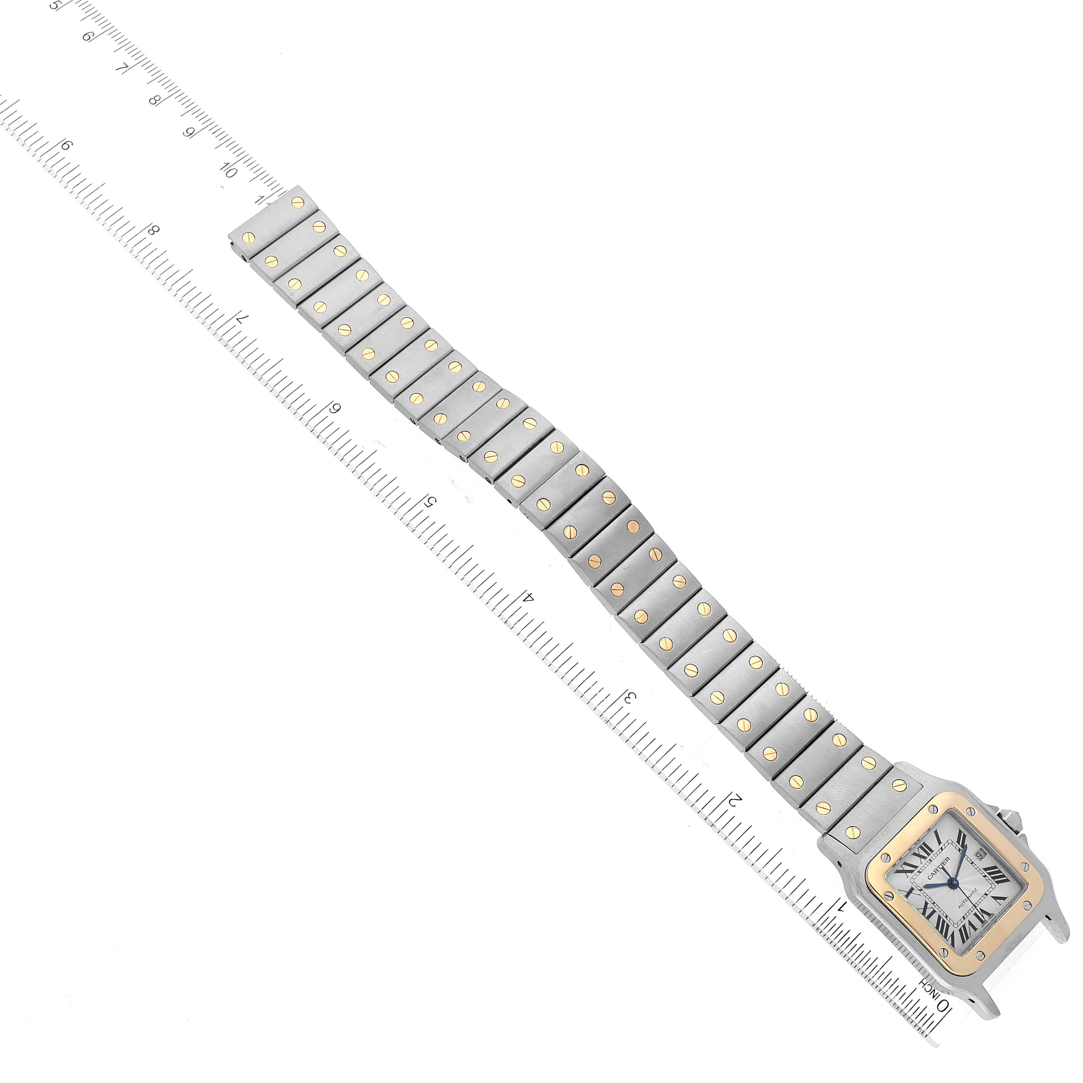 The image shows a top-down view of a Cartier Santos W20058C4 Men
s Steel and Gold (two tone) Silver Dial W20058C4 Men
s Steel and Gold (two tone) Silver Dial watch, featuring its full bracelet and square case with a gold bezel.
