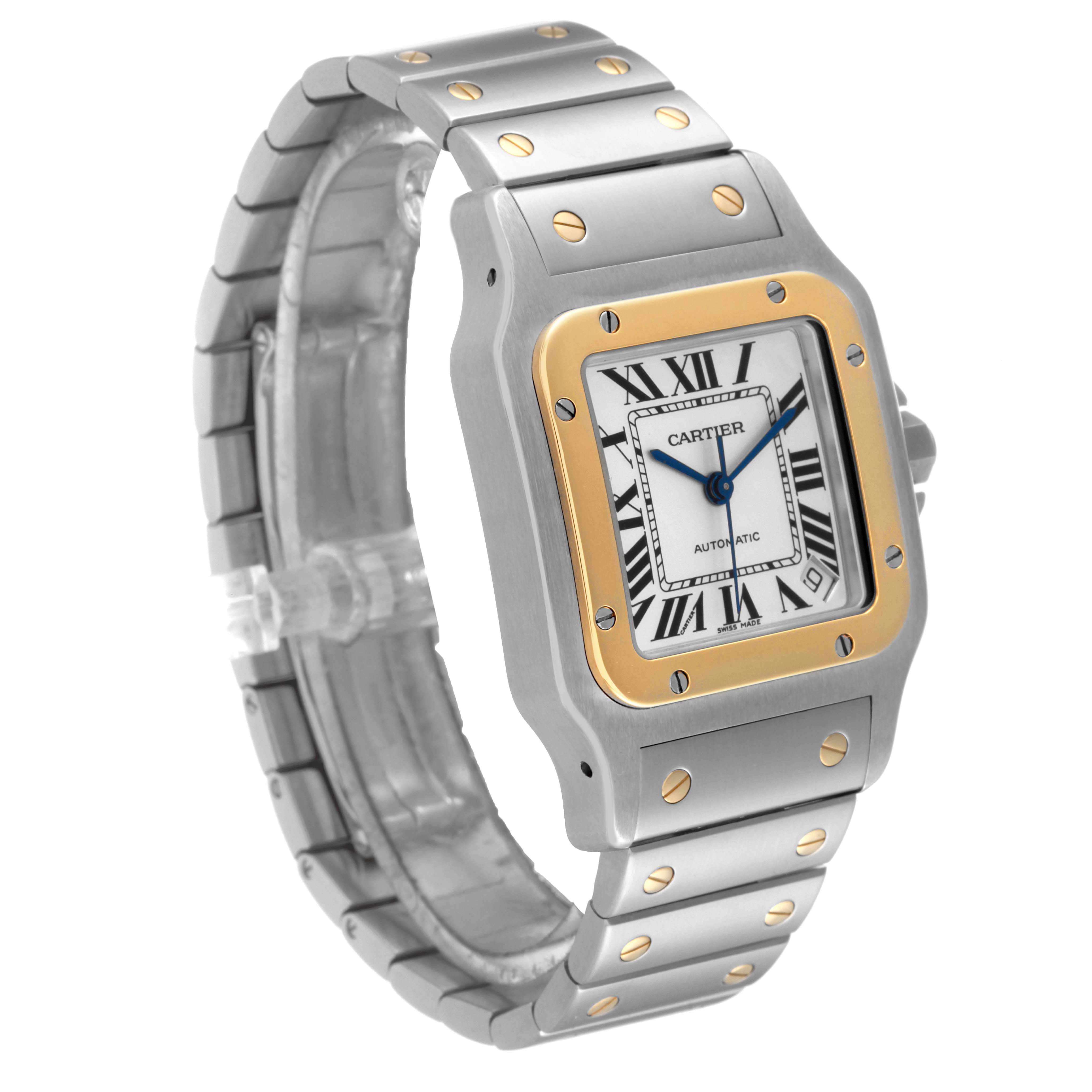 The image shows a Cartier Santos W20099C4 Men
s Steel and Gold (two tone) Silver Dial W20099C4 Men
s Steel and Gold (two tone) Silver Dial watch from an oblique angle, featuring its face, bezel, and bracelet.