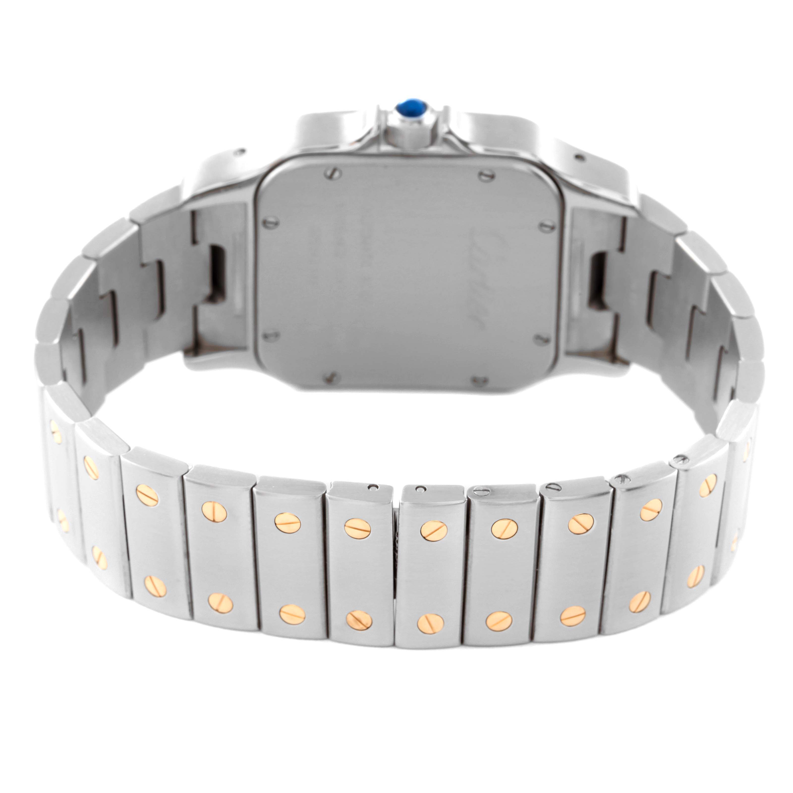 The Cartier Santos W20099C4 Men
s Steel and Gold (two tone) Silver Dial W20099C4 Men
s Steel and Gold (two tone) Silver Dial watch is shown from the back, highlighting its bracelet and case back with screws and blue gem on the crown.