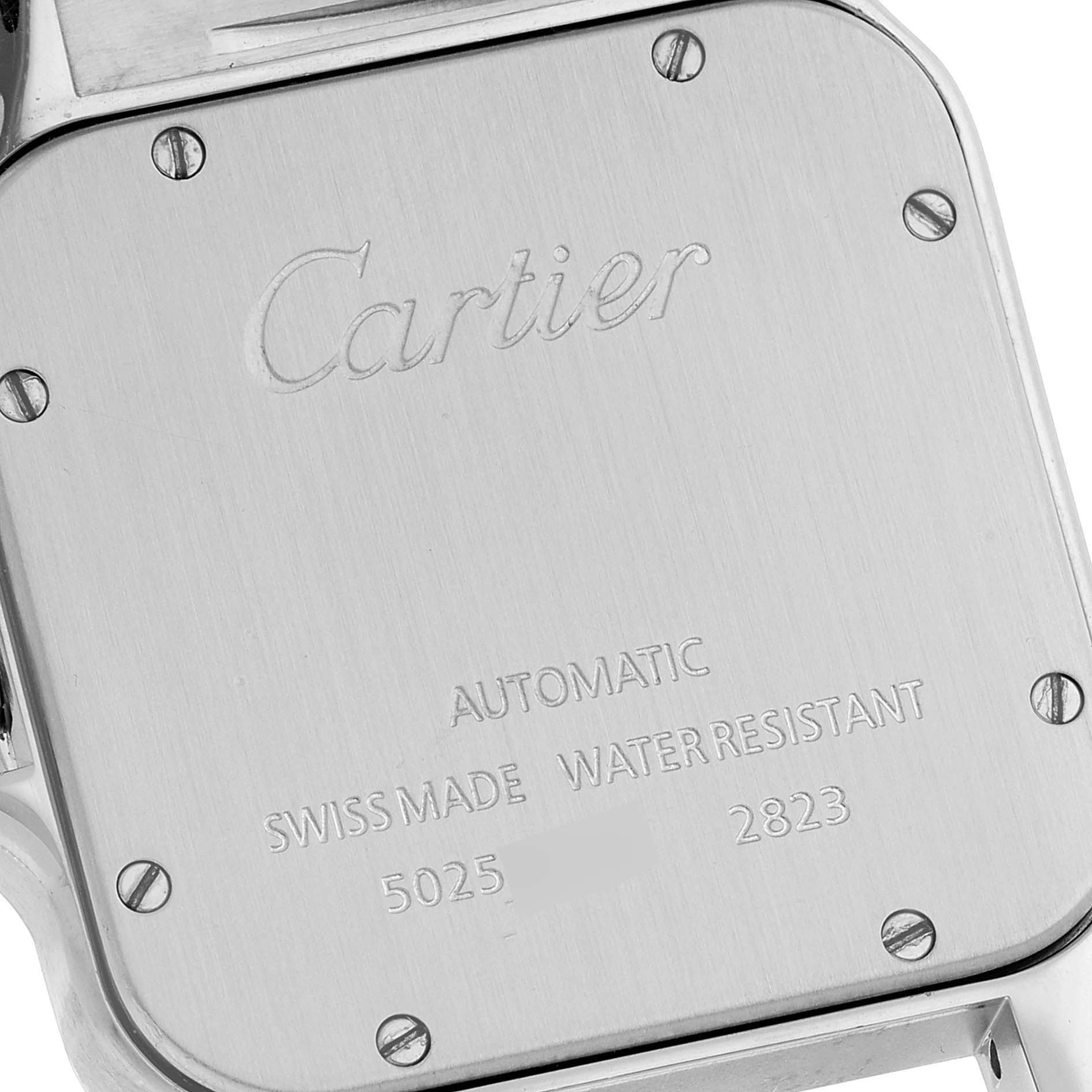 The image shows the back case of a Santos model watch by Cartier, displaying the brand name and various engravings.