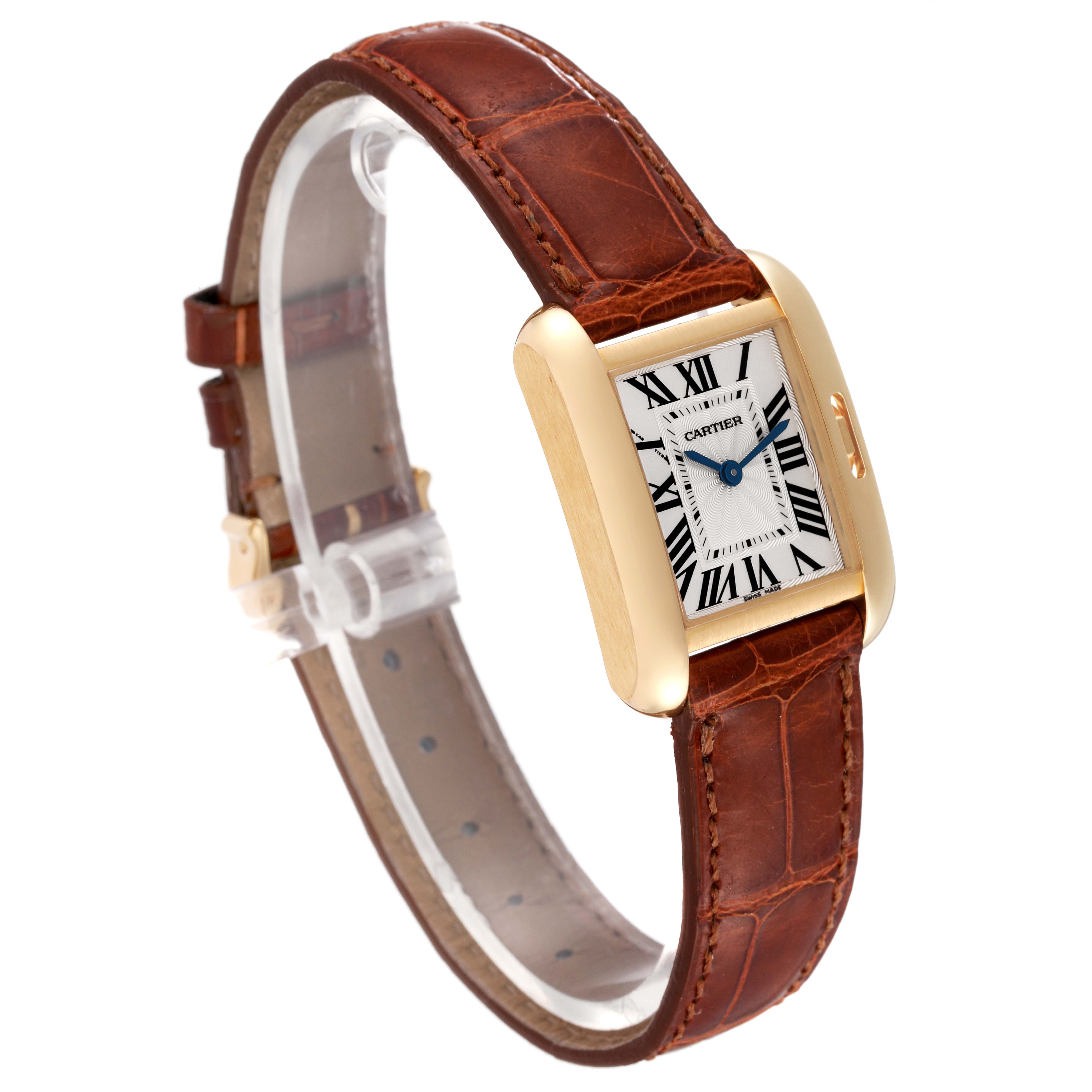 The Tank Anglaise by Cartier is shown at a slight angle, displaying its rectangular dial with Roman numerals and brown leather strap.