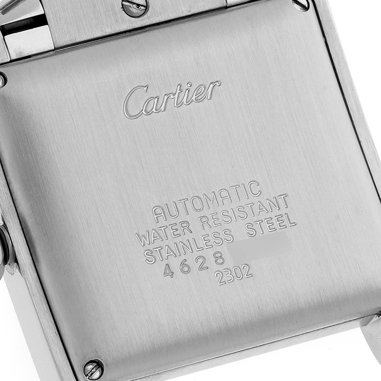 This image shows the back case of a Cartier Tank Francaise W51002Q3 Men's Stainless Steel Silver Dial W51002Q3 Men's Stainless Steel Silver Dial watch, featuring engraved text and surrounding screws.