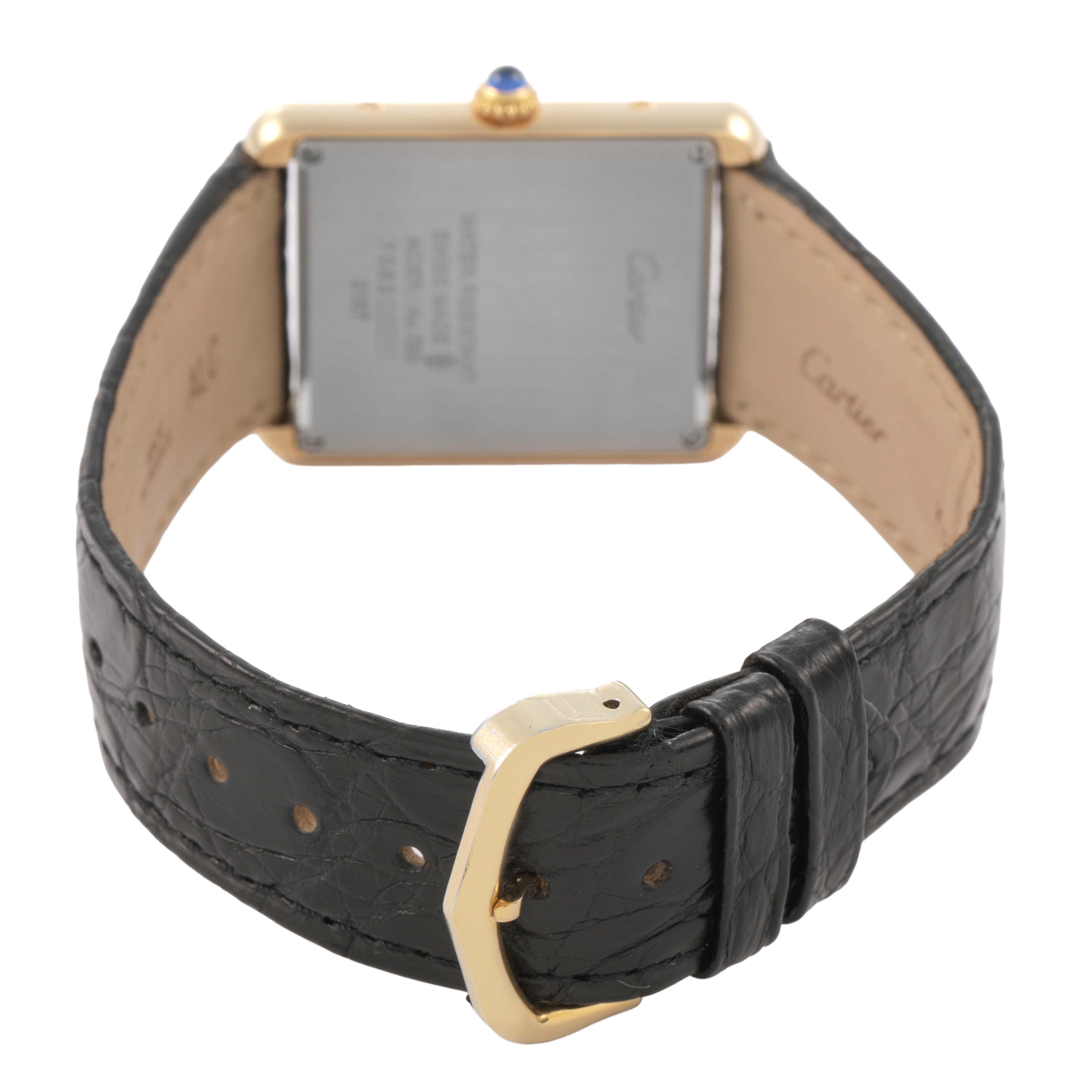 The Cartier Tank Solo W5200004 Men's Yellow Gold Silver Dial watch is shown from the back, highlighting the case back, crown, and leather strap with buckle.