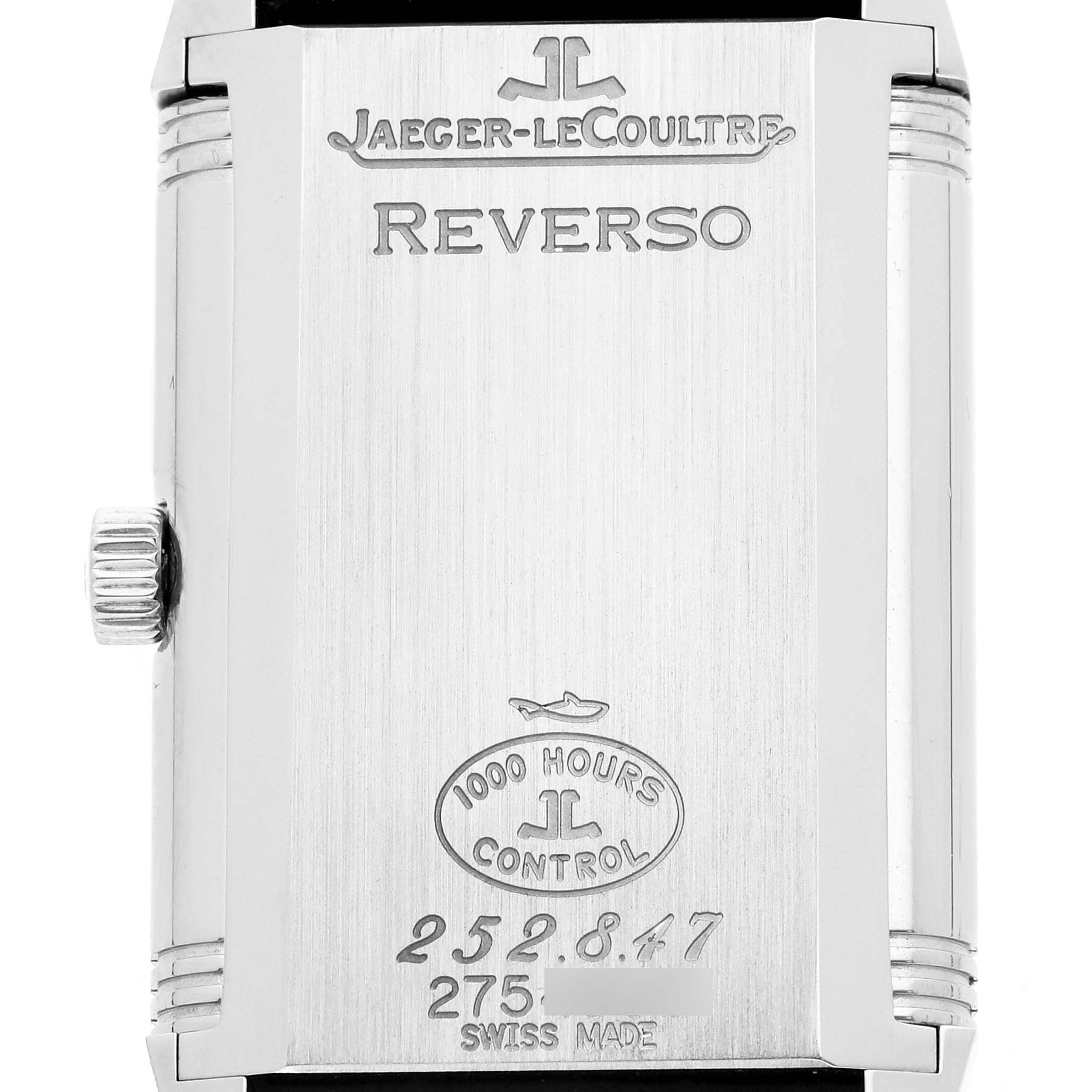 The image shows the back of the Jaeger-LeCoultre Reverso watch featuring engravings and a crown on the left.