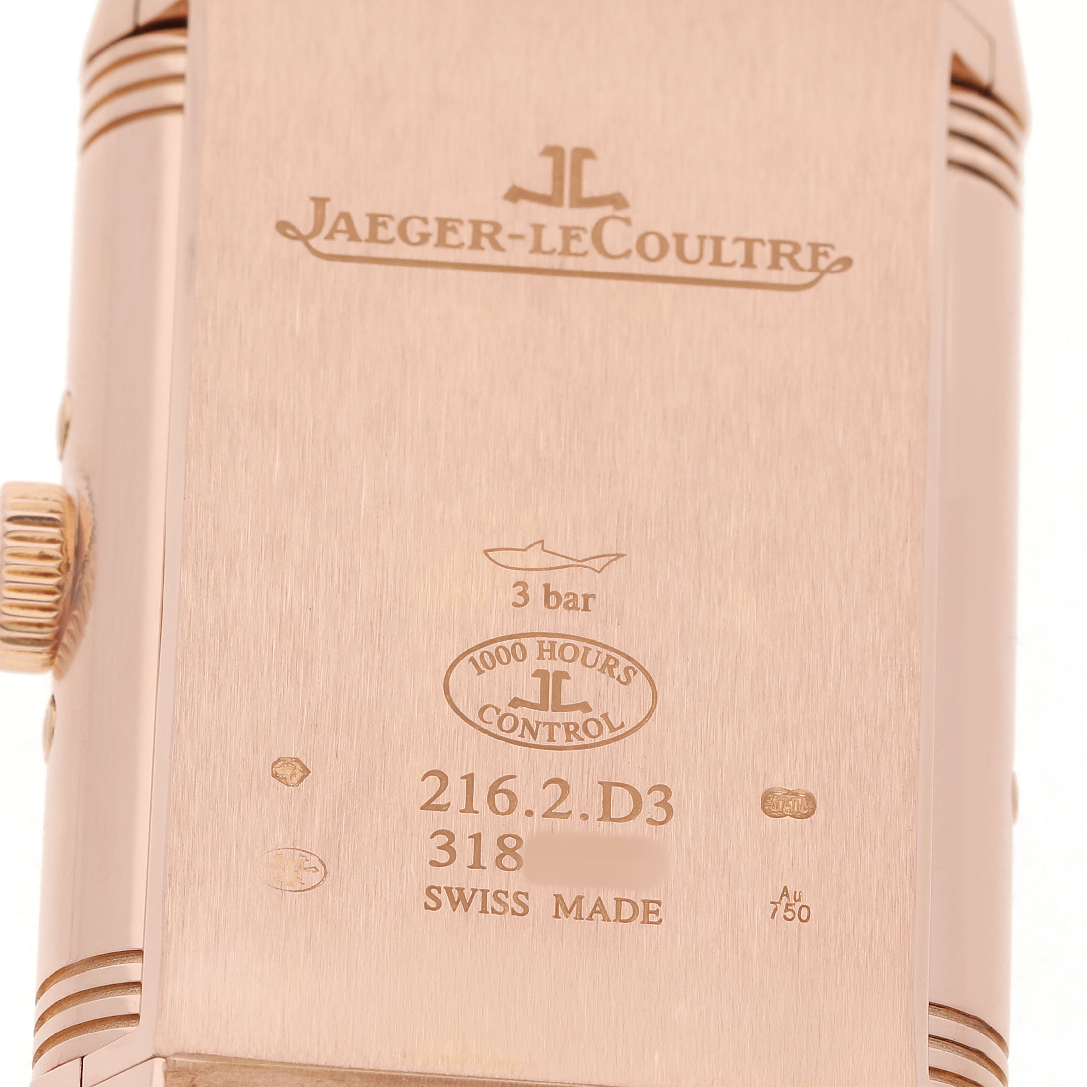 The image shows the back of a Jaeger-LeCoultre Reverso watch, highlighting the brand engraving and model details.