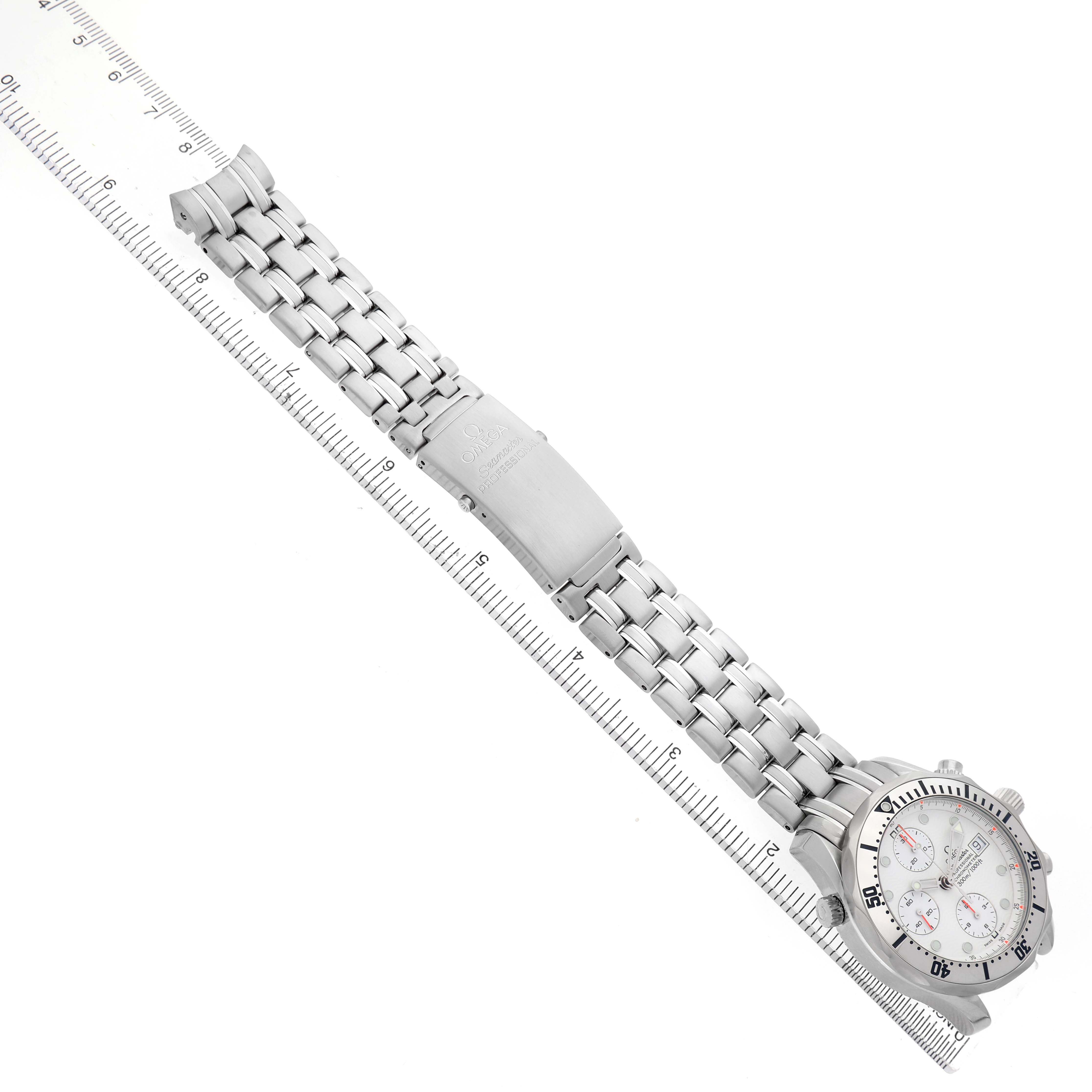The Omega Seamaster 2598.20.00 Men's Stainless Steel White Dial watch is shown from a top-down angle, displaying the face, bezel, and full bracelet alongside a ruler.