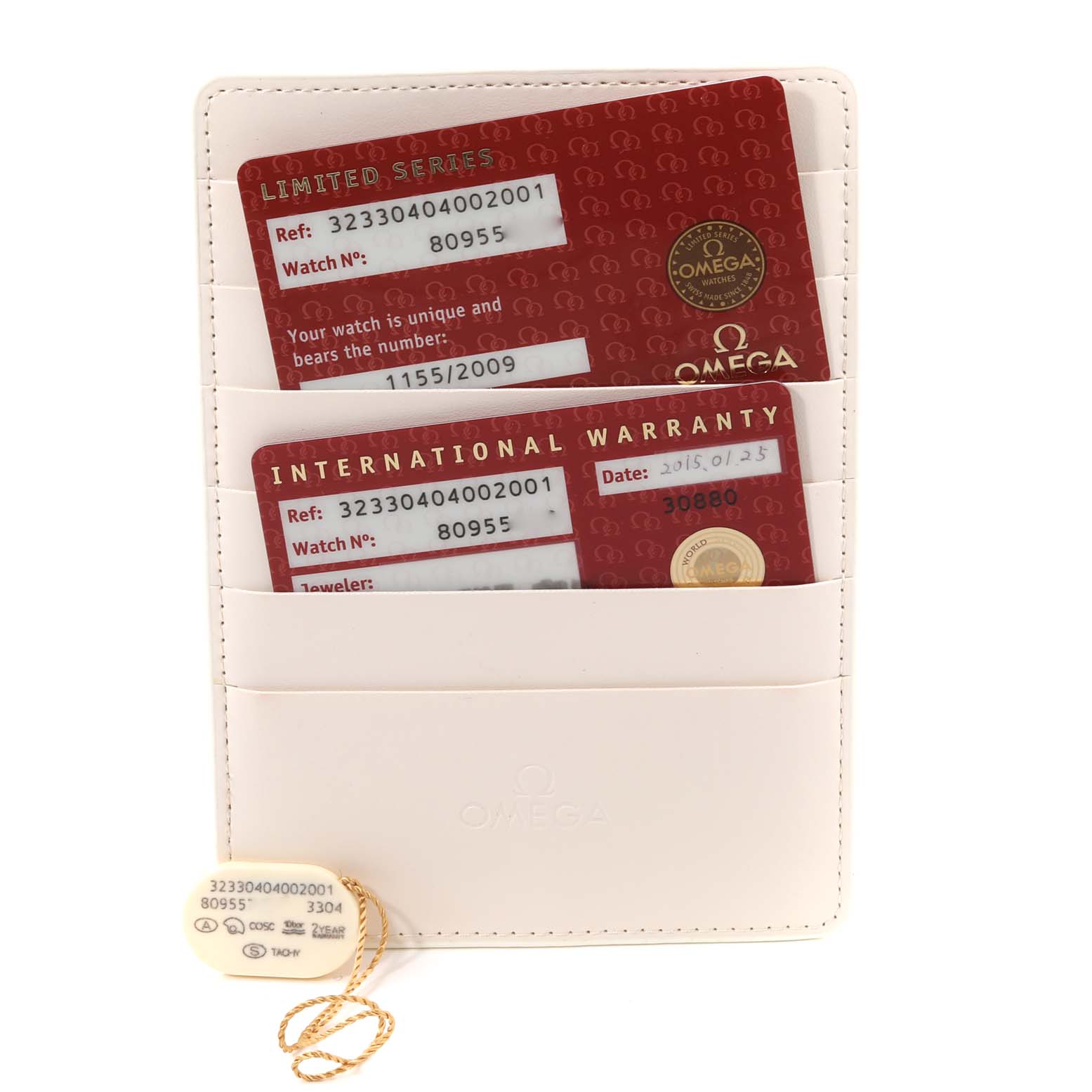 This image shows the warranty cards and a tag for the Omega Speedmaster 323.30.40.40.02.001 Men's Stainless Steel White Dial 323.30.40.40.02.001 Men's Stainless Steel White Dial watch, displayed in a white holder.