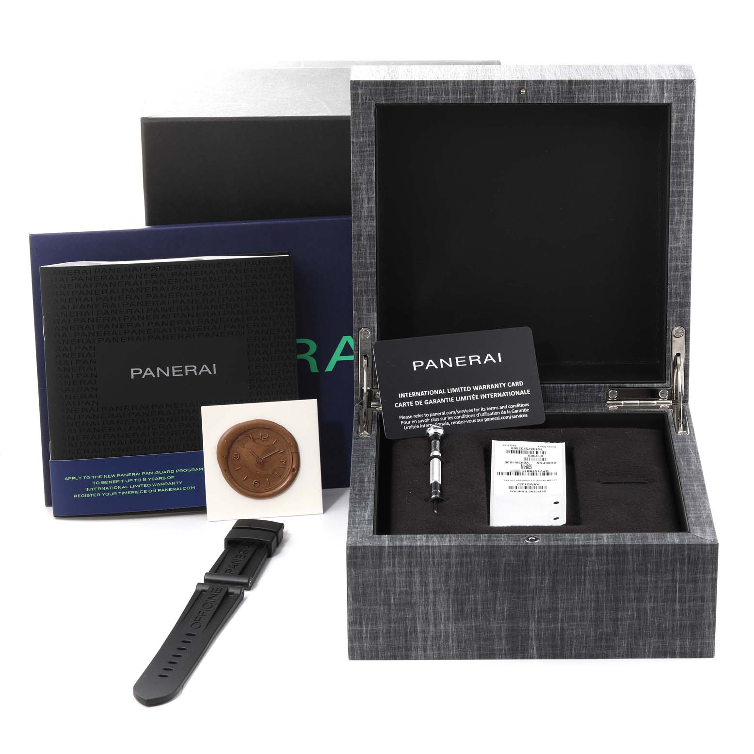 The image shows the open box of a Panerai Luminor PAM01037 Men's Ceramic Black Dial PAM01037 Men's Ceramic Black Dial watch with accessories, a warranty card, and manuals at a slight upward angle.