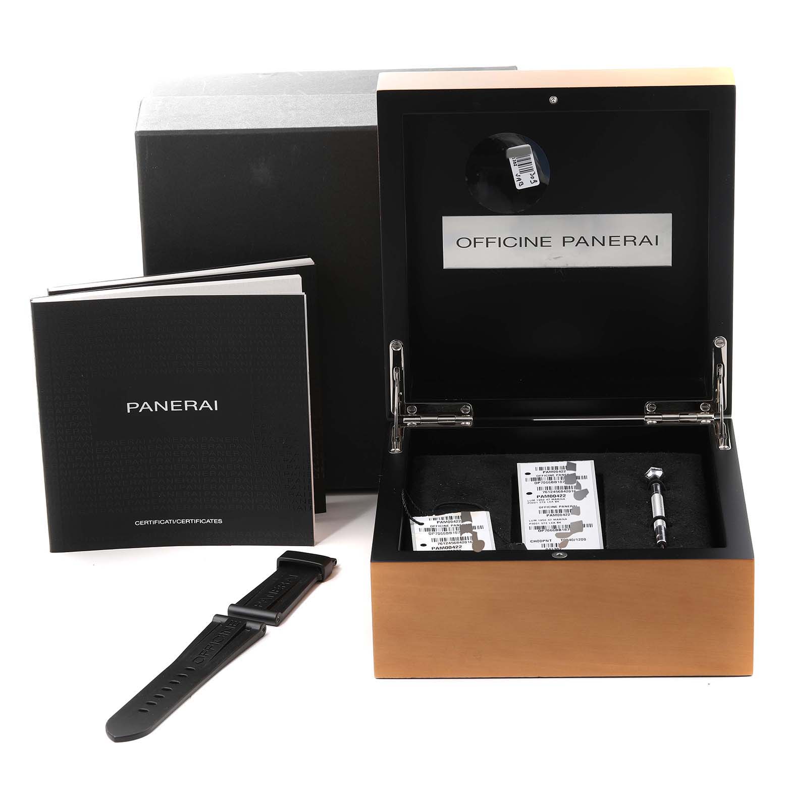 The image shows the opened box of a Panerai Luminor PAM00422 Men
s Stainless Steel Black Dial PAM00422 Men
s Stainless Steel Black Dial watch, along with booklets, an extra strap, and tools from a front angle.