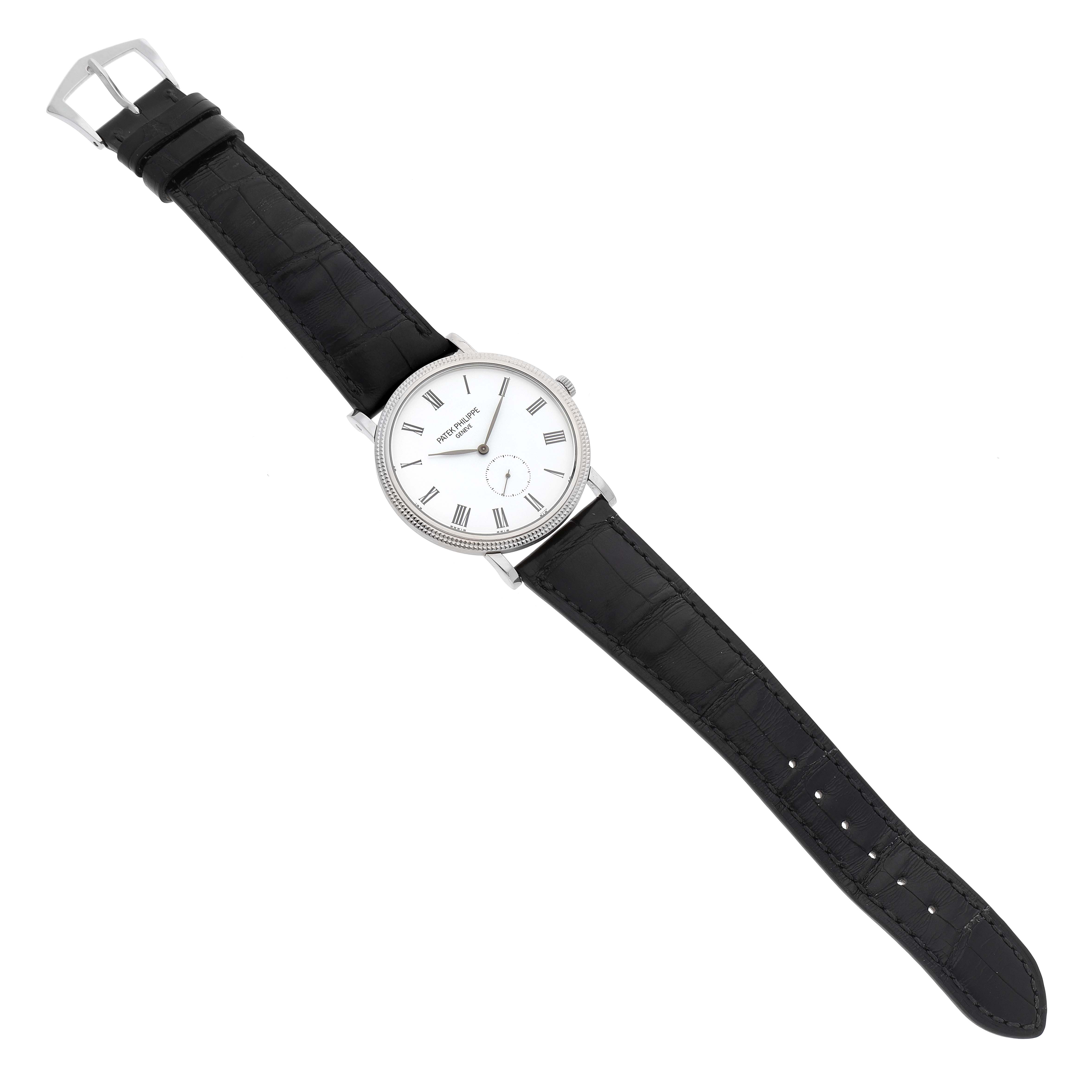 The image shows a Patek Philippe Calatrava 5119G Men's White Gold White Dial 5119G Men's White Gold White Dial watch, captured from a top-down angle, displaying the watch face, straps, and buckle.