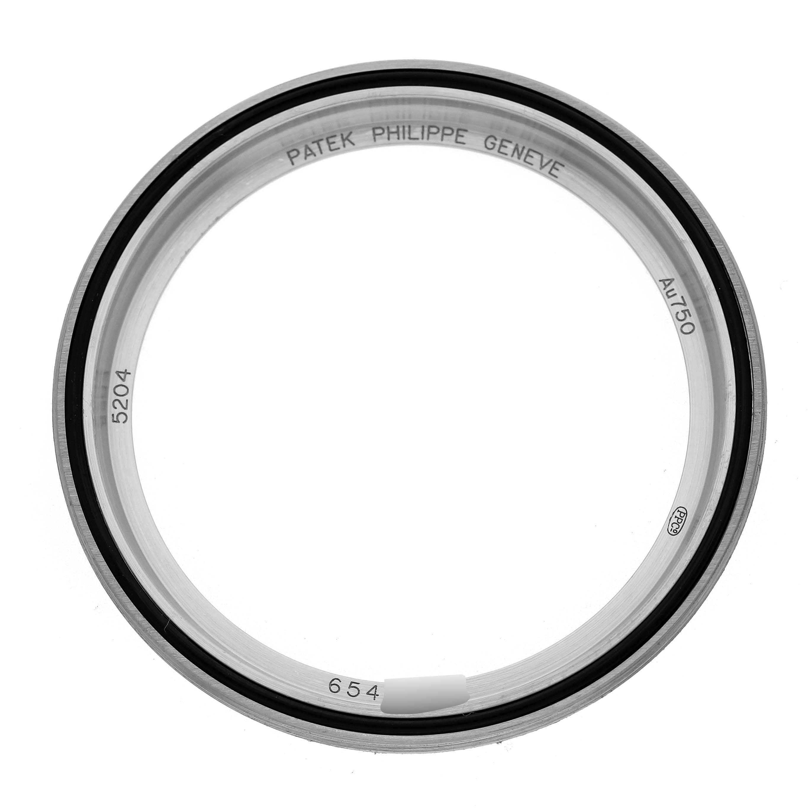 The image shows a round bezel or watch ring for the Patek Philippe Complications 5204G-001 Men's White Gold Green Dial model, viewed from a top perspective.