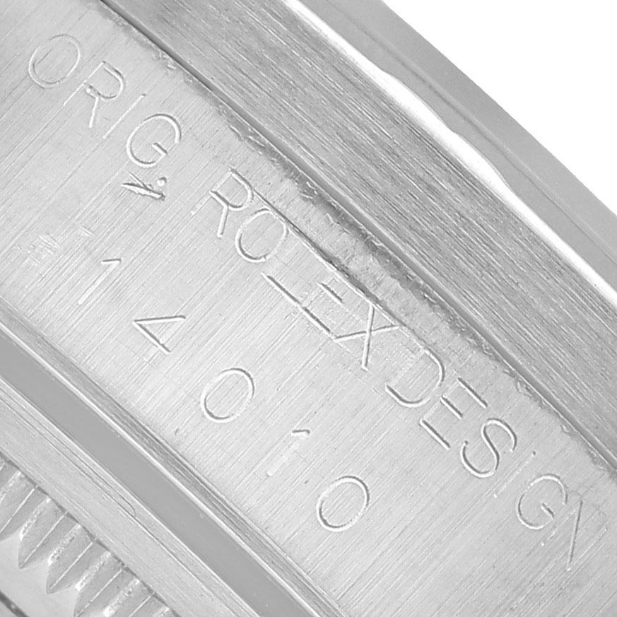This image shows a close-up of the engraved case side of a Rolex Air-King 14010 Men's Stainless Steel White Dial watch, displaying "ORIG ROLEX DESIGN 14010."