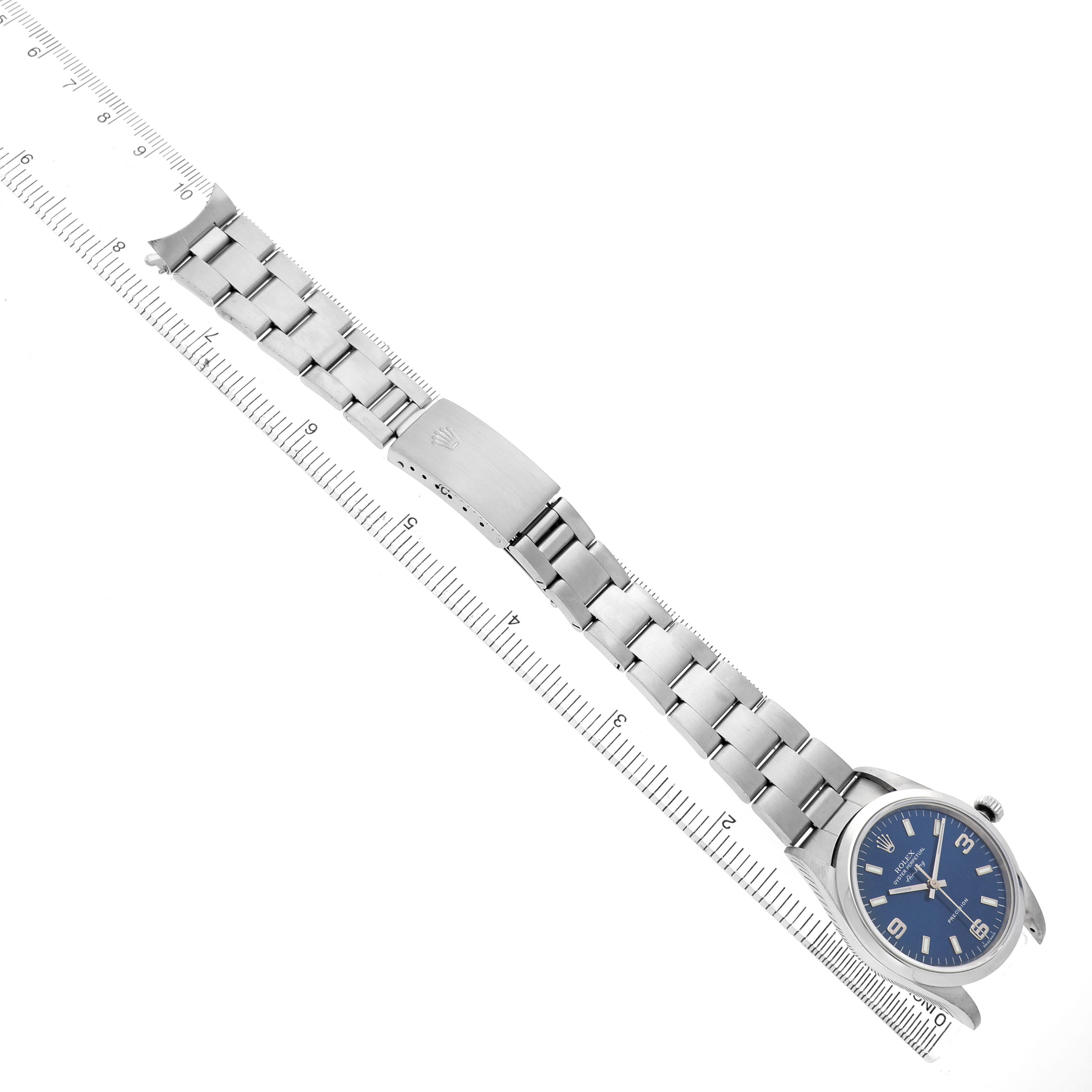 The Rolex Air-King 14000M Men's Stainless Steel Blue Dial watch is shown from a top view, displaying the full bracelet, clasp, and face alongside a ruler for scale.